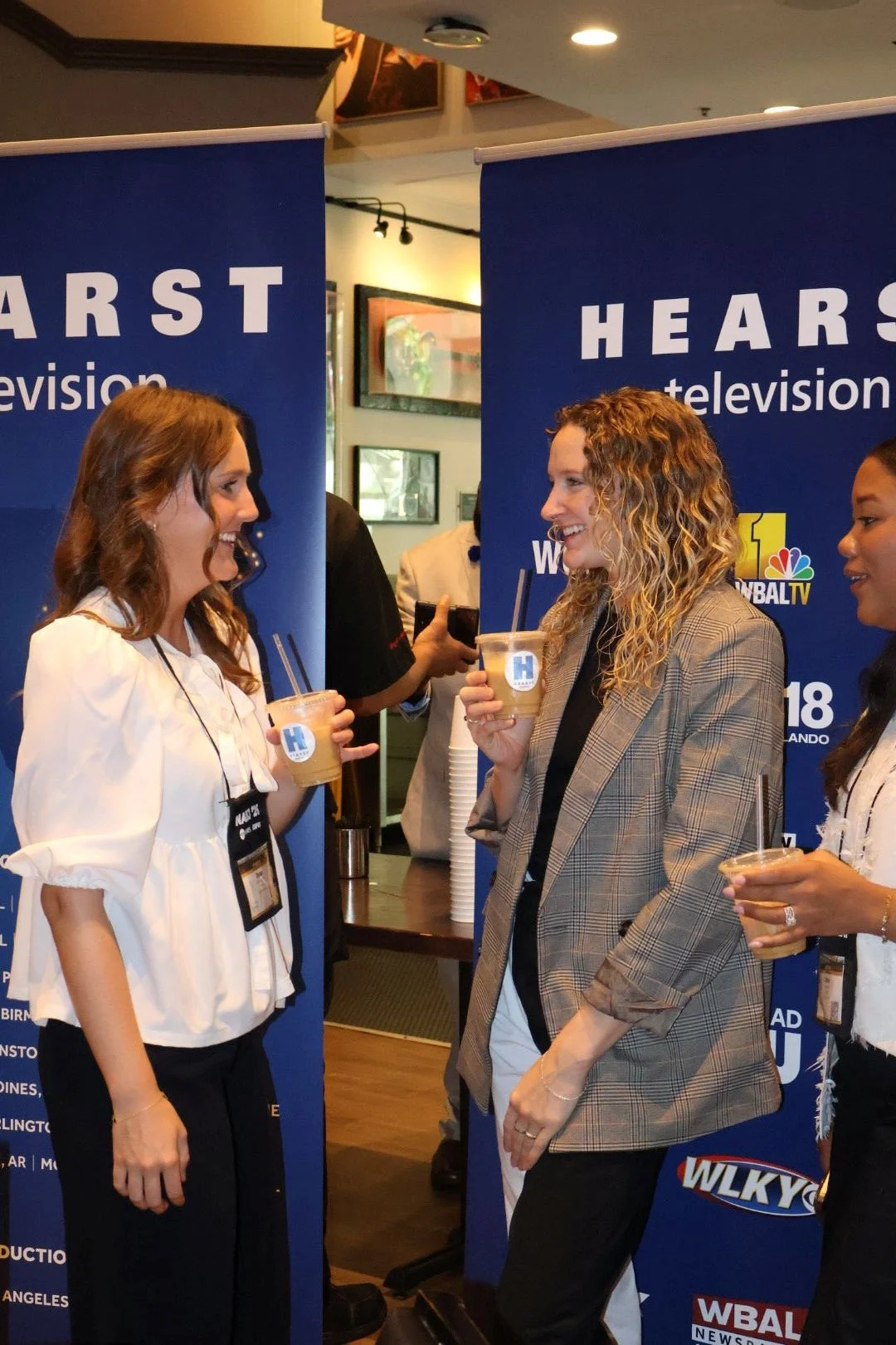 Guests chatting near the coffee bar at a corporate recruiting event