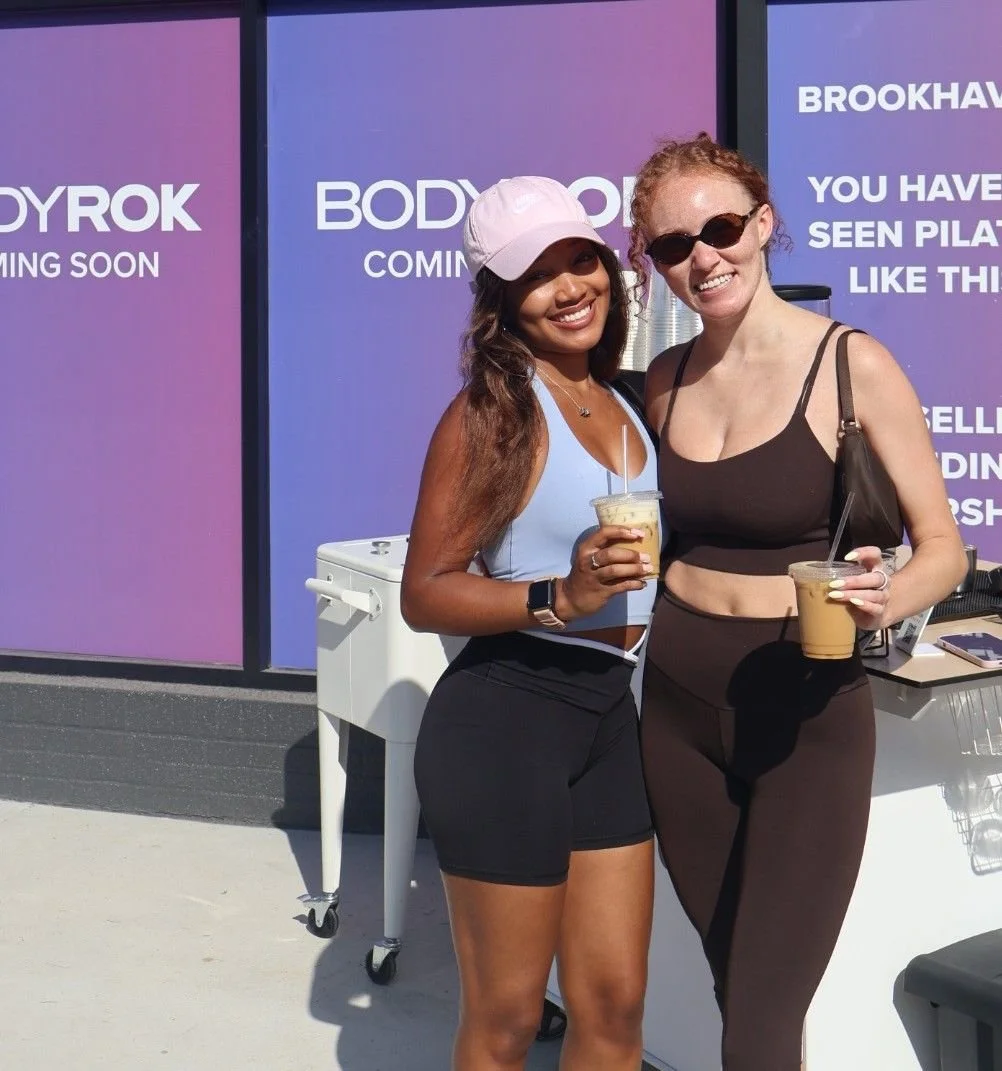 Woman enjoying iced coffee outside Pilates studio during Atlanta coffee catering event
