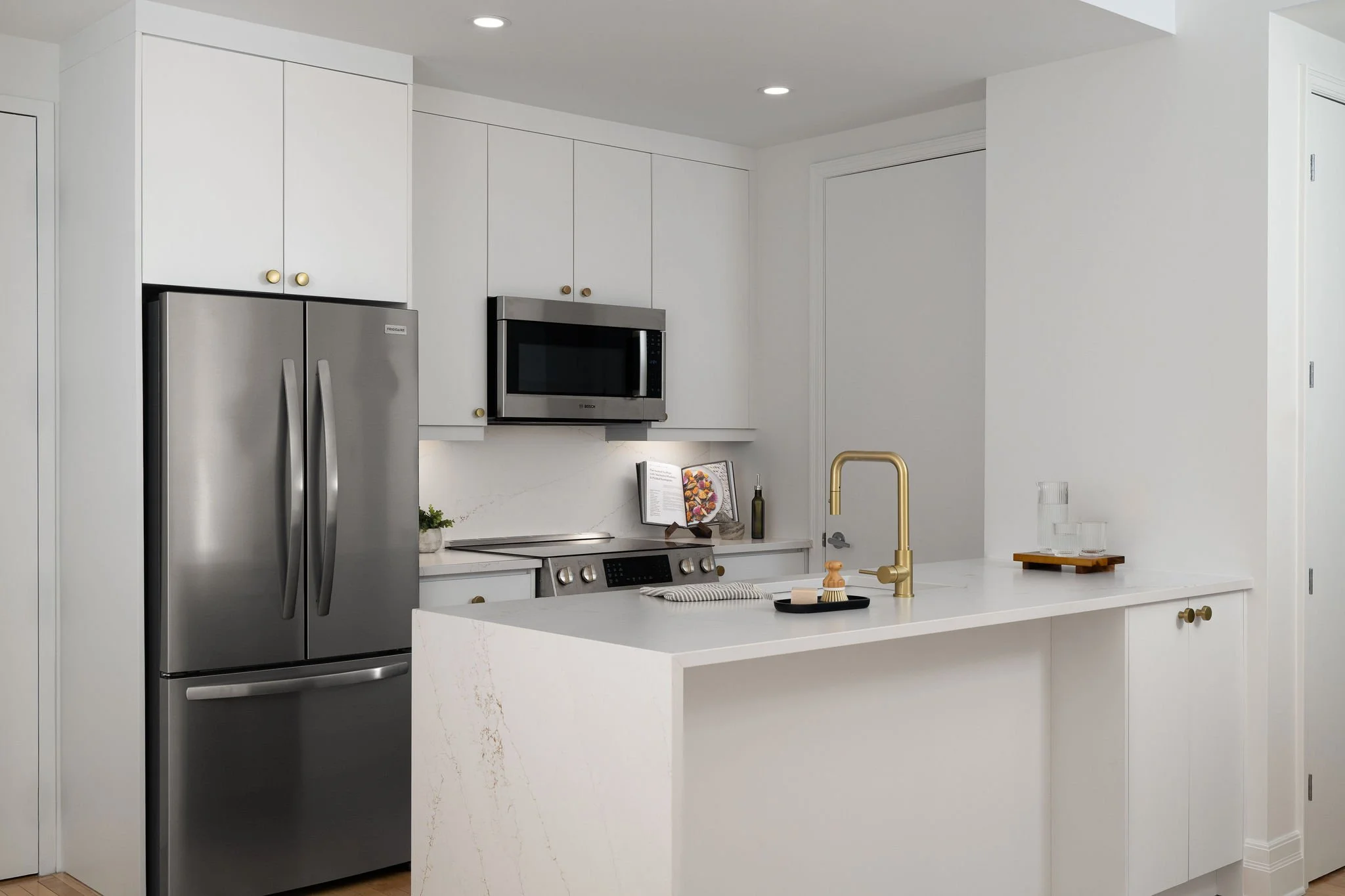 White Kitchen with Gold Fixtures & Waterfall Island Coutertop_3.jpg