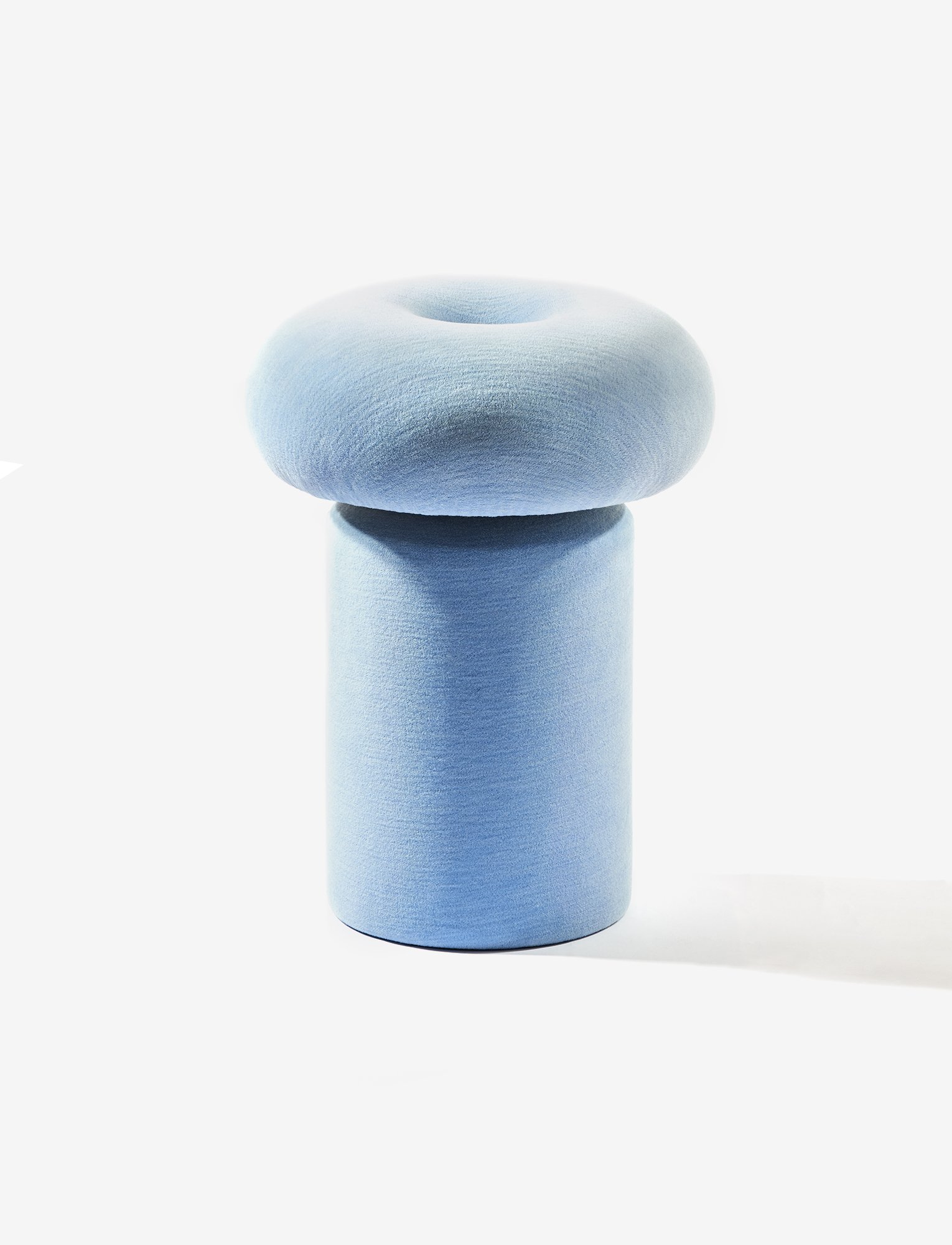 Soufflé Stool in its soft fully-upholstered donut version, defined by its plush rounded volume and gentle textile contours within the Ourse collection.