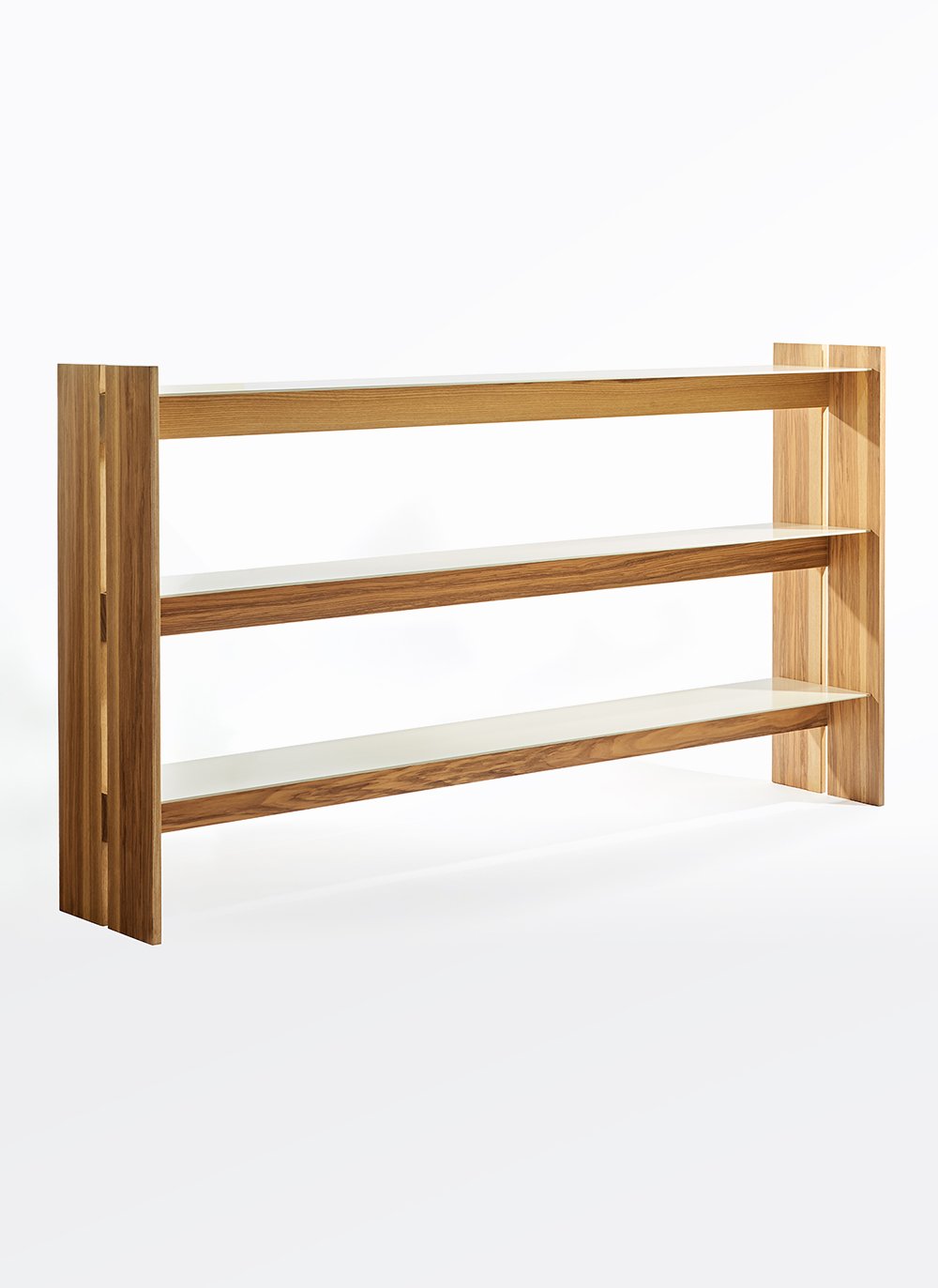 Tract Shelf defined by its rhythmic vertical supports, wide span and open horizontal coloured aluminum planes, offering an airy architectural storage composition within the Ourse range.
