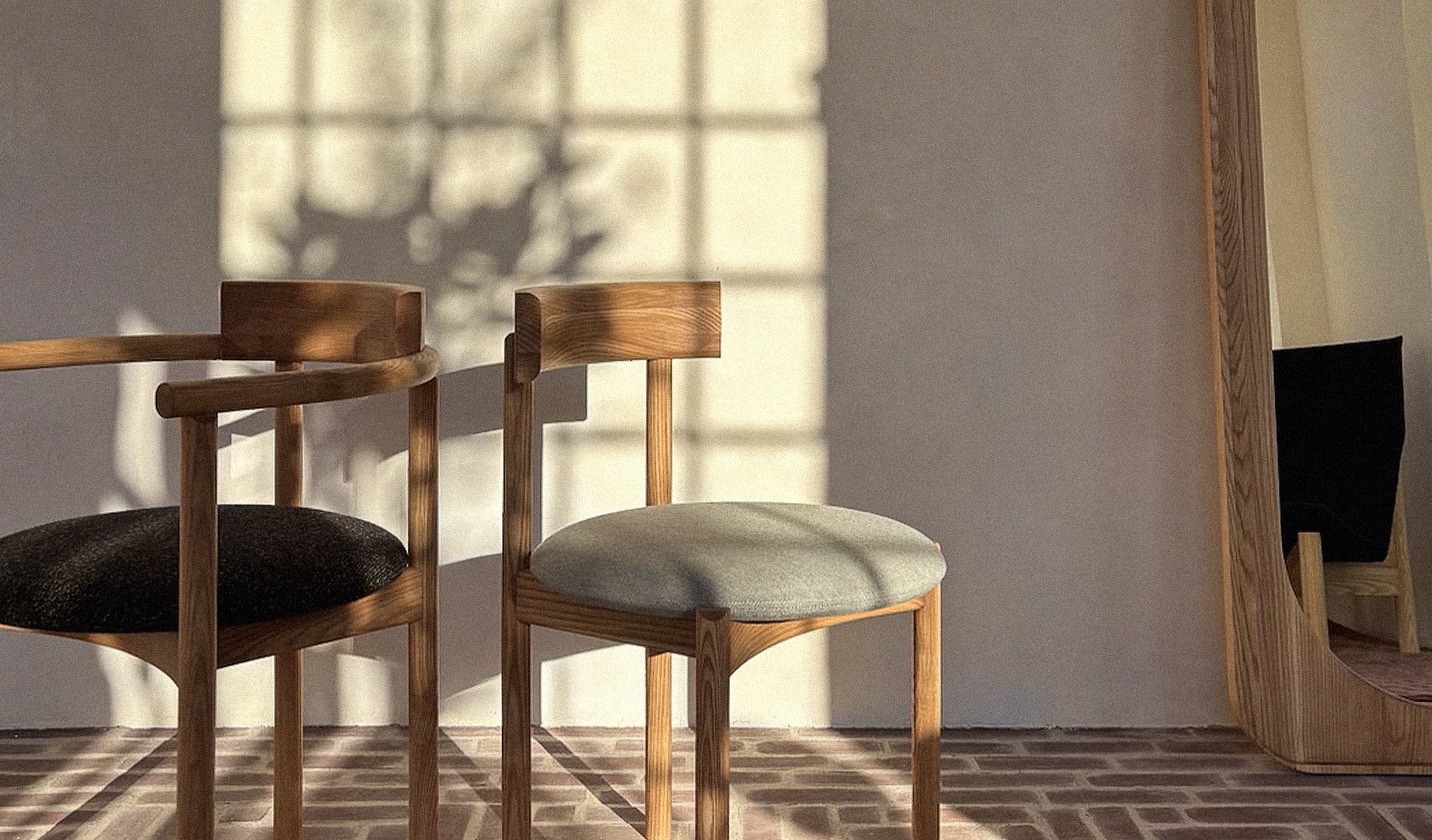 Two contemporary Canadian-made abbey chairs in a studio setting, illustrating Ourse’s focus on local craftsmanship and modern design.