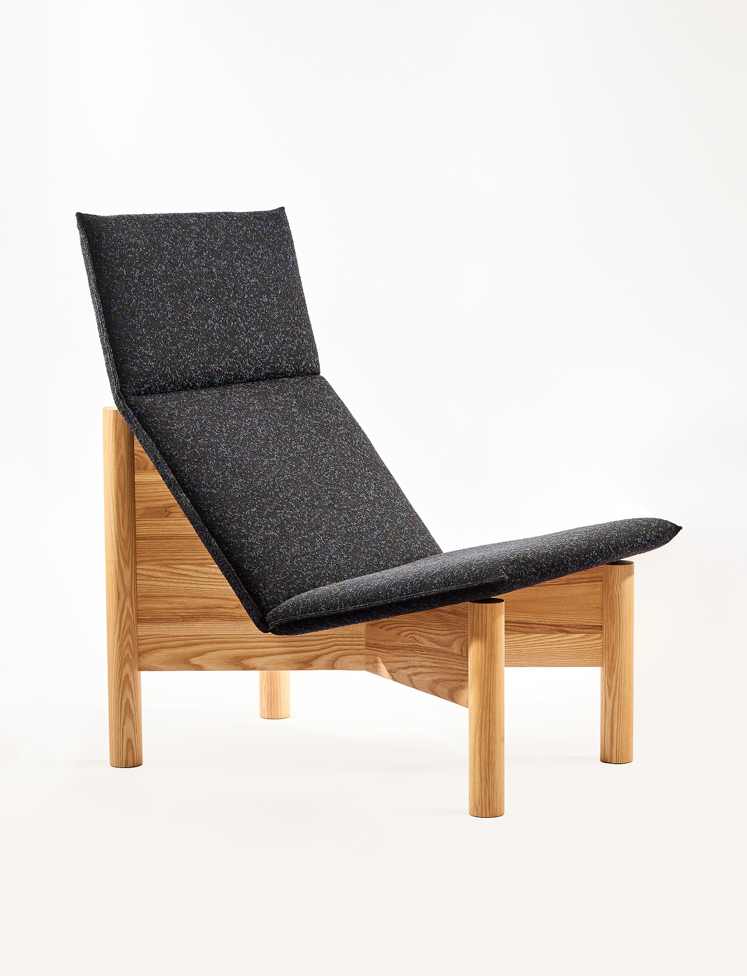 Alder Lounge Chair with soft sculpted cushions and solid wood frame, part of the Ourse modern furniture collection.