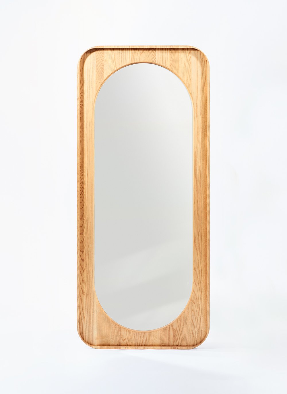 Farfalle Mirror with pinched corner contours and a waterfall bullnose detail, this full length mirror is shown as part of the Ourse series.