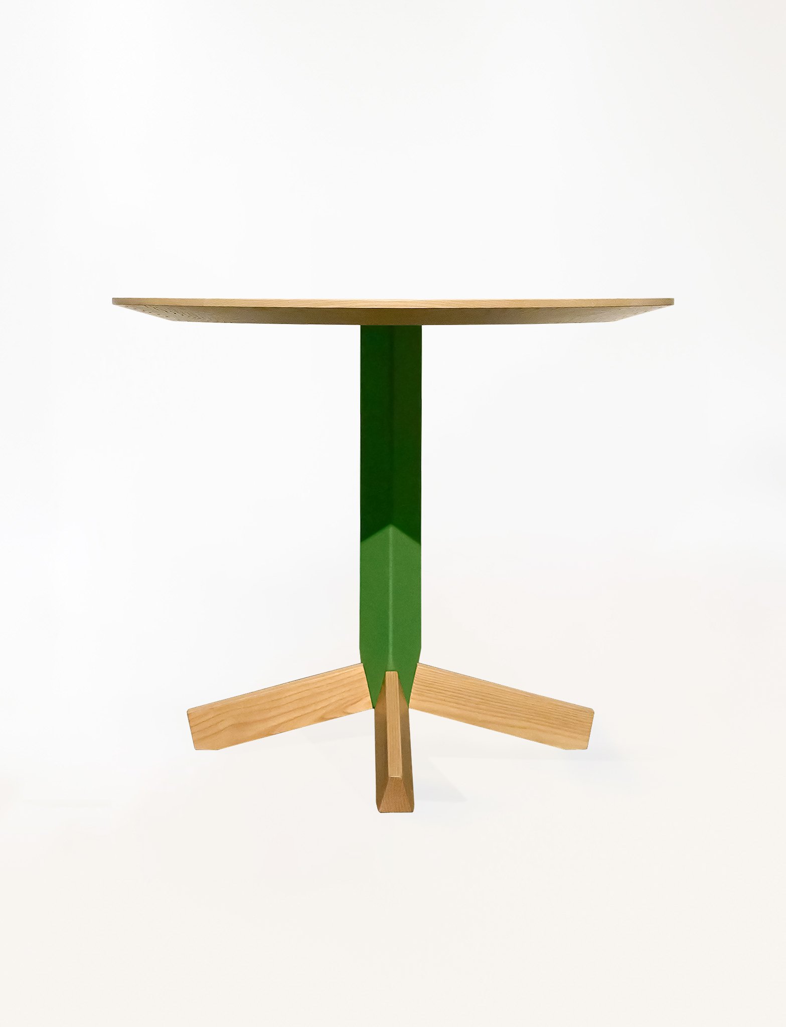 Peggy Table featuring a rounded tabletop set on a faceted central base, highlighting its balanced proportions, customizable materials, and quiet sculptural presence in the Ourse lineup.