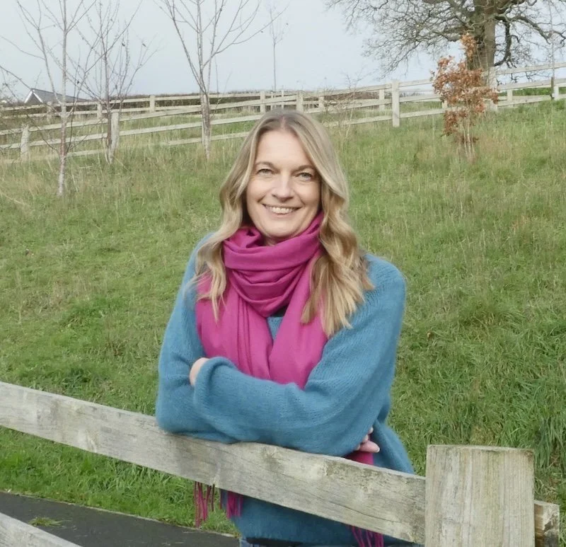 kathy director of seymour research leaning on a fence