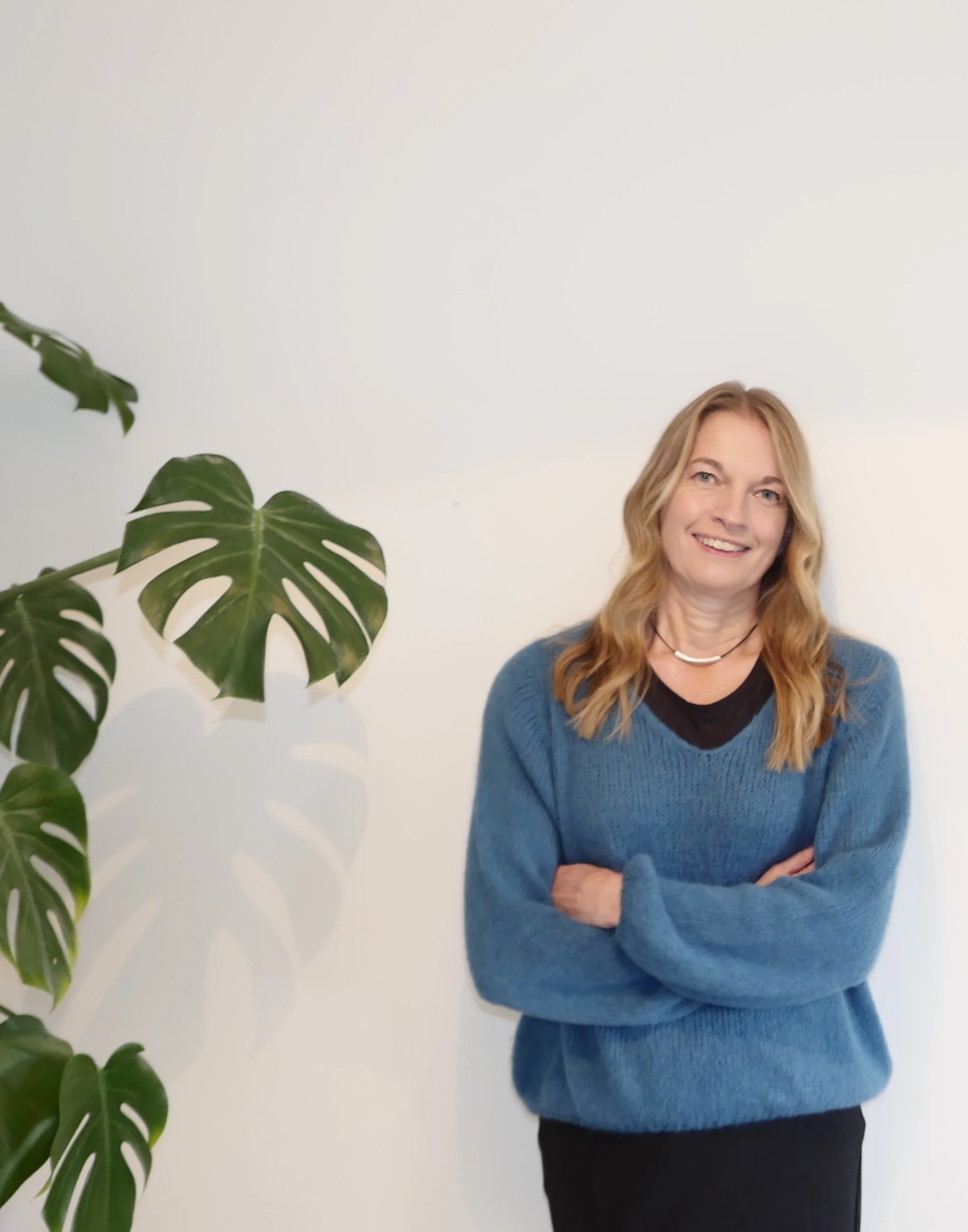 kathy director of seymour research standing next to a large plant