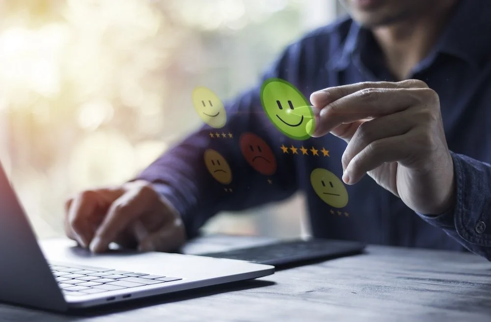 man reviewing feedback on a laptop