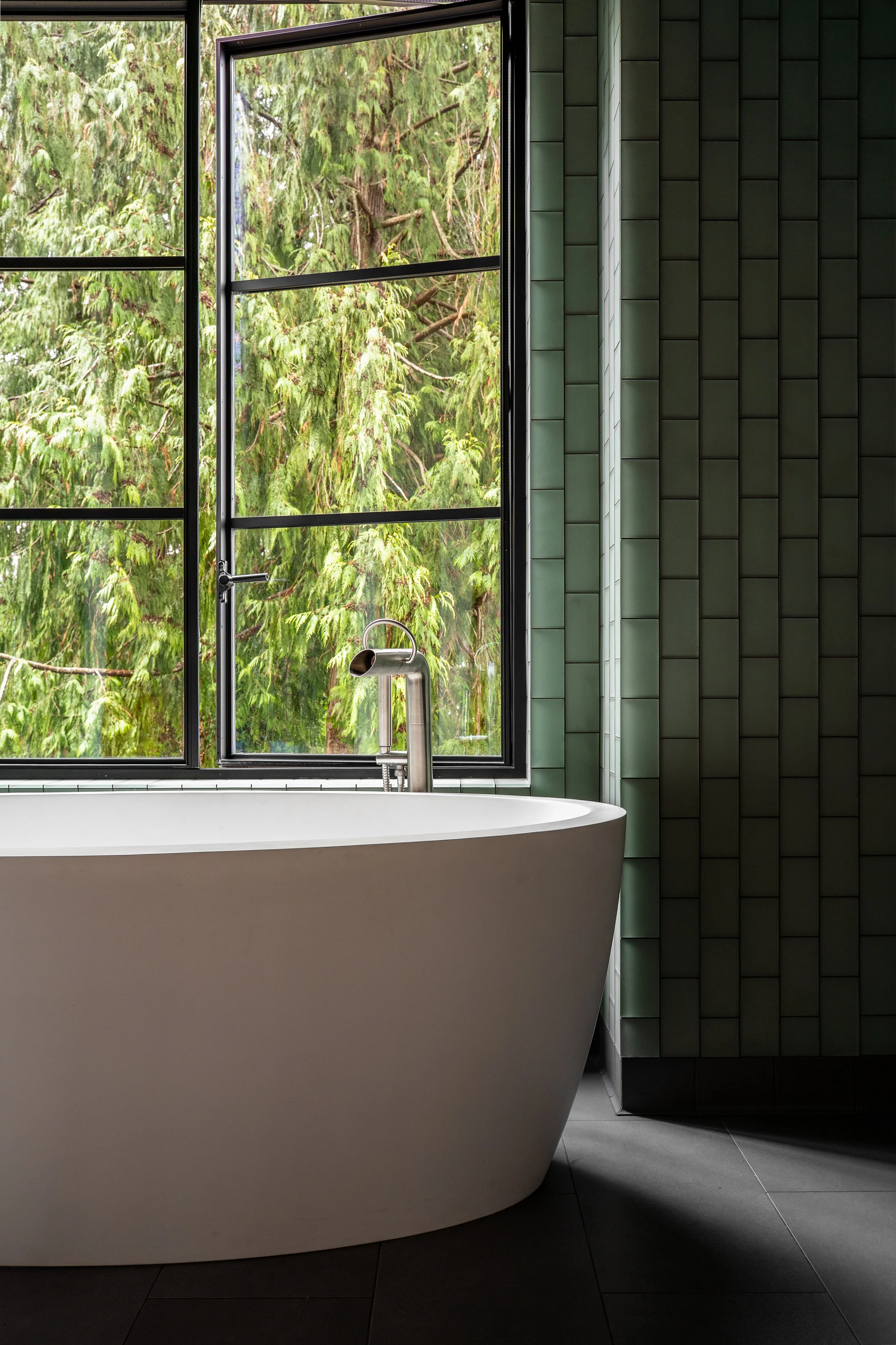 Bainbridge Island | New Construction | Bath tub in front of open windows and trees