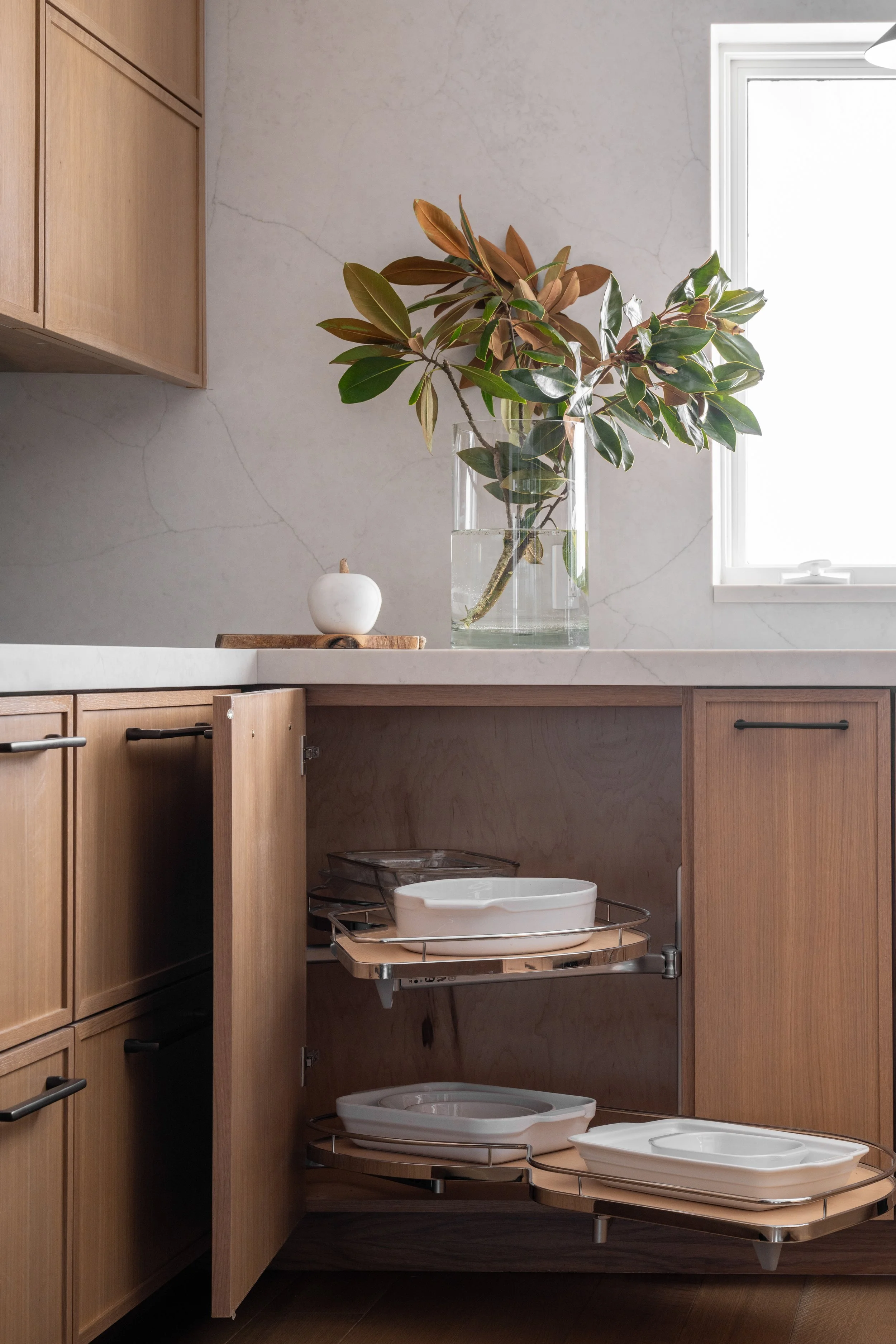Gig Harbor, WA | Kitchen Remodel | Corner cabinet storage containing ceramic baking dishes