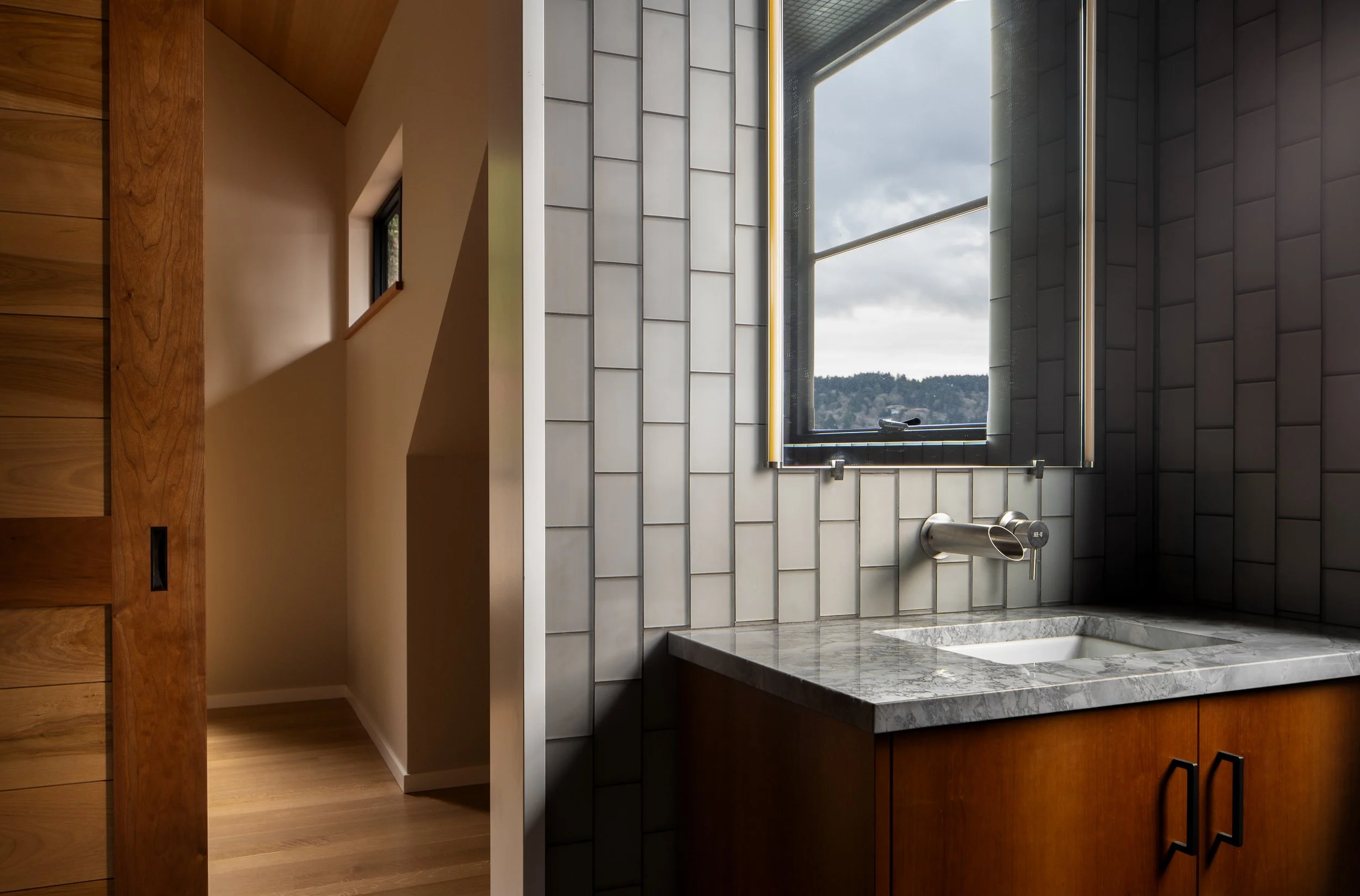 Bainbridge Island | New Construction | Tiled Bathroom with vanity and mirror