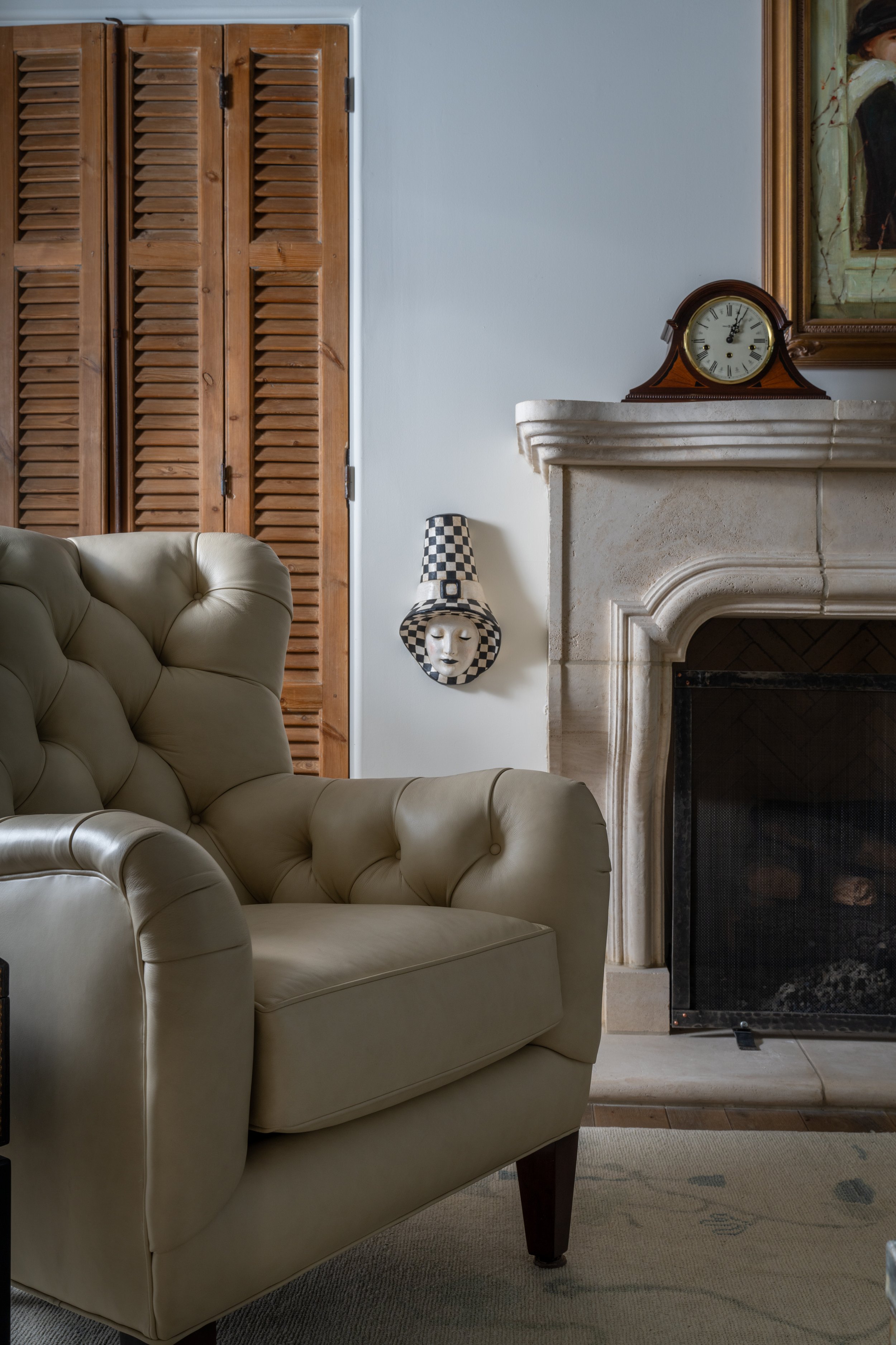 Blanco TX | Living Room | Concrete Fireplace and Leather chair with antique shudders
