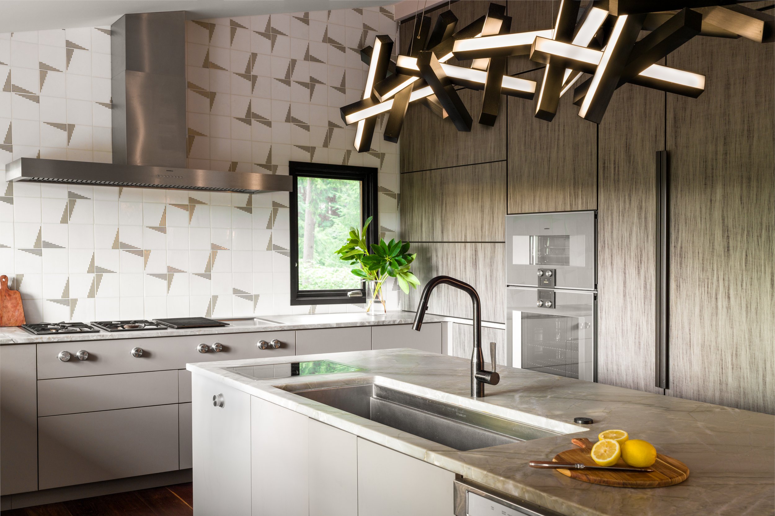 Gig Harbor, WA | Kitchen Remodel | Island featuring a sink and large sculptural light fixture