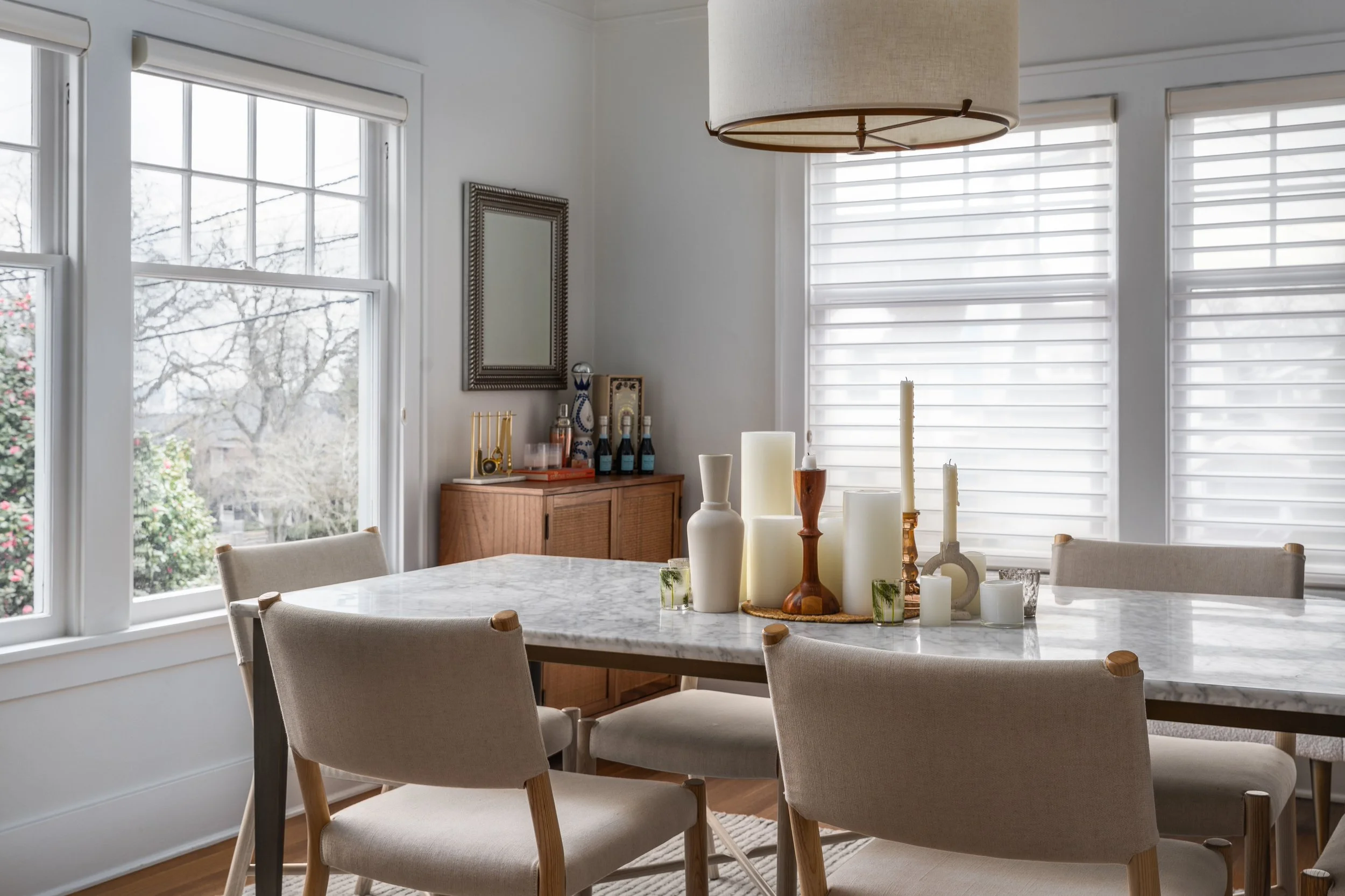 Queen Anne, Seattle | Dining Room Remodel | Rectangle marble table with upholstered chairs in white room with windows
