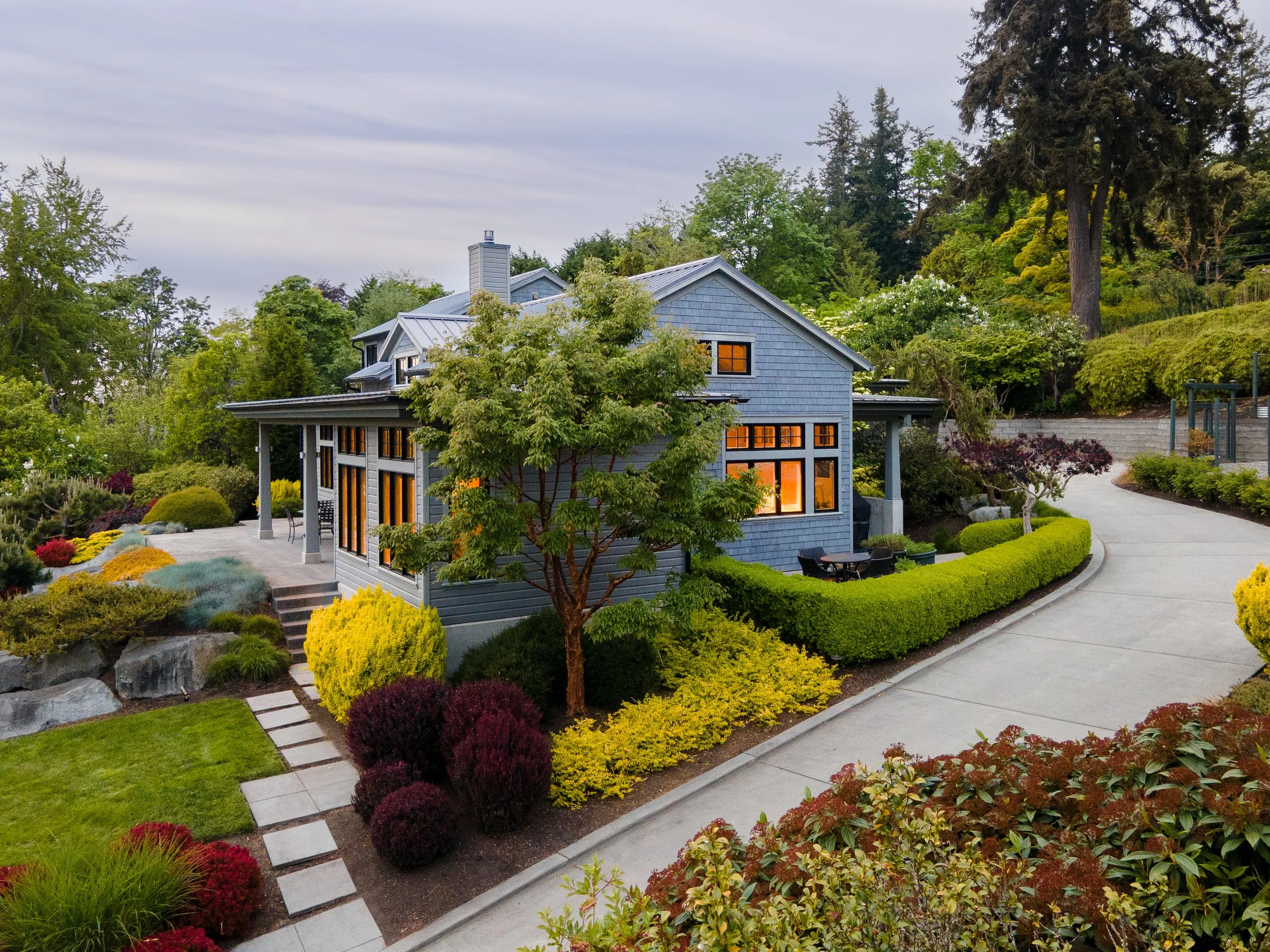 Bainbridge Island, WA | New Construction | House Exterior at dusk with lush landscaping