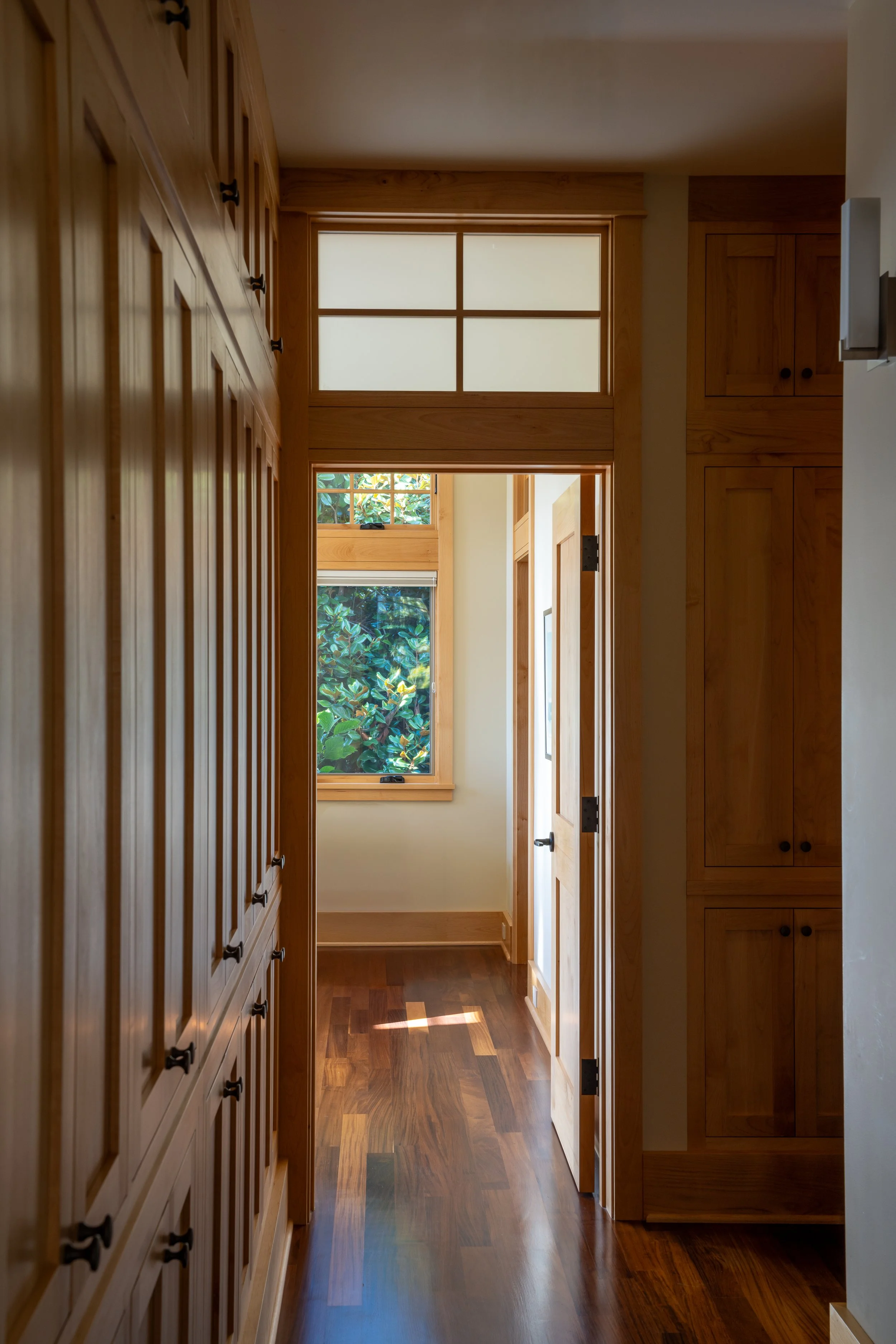 Bainbridge Island, WA | New Construction | Wood Cabinets Line hallway to primary bedroom