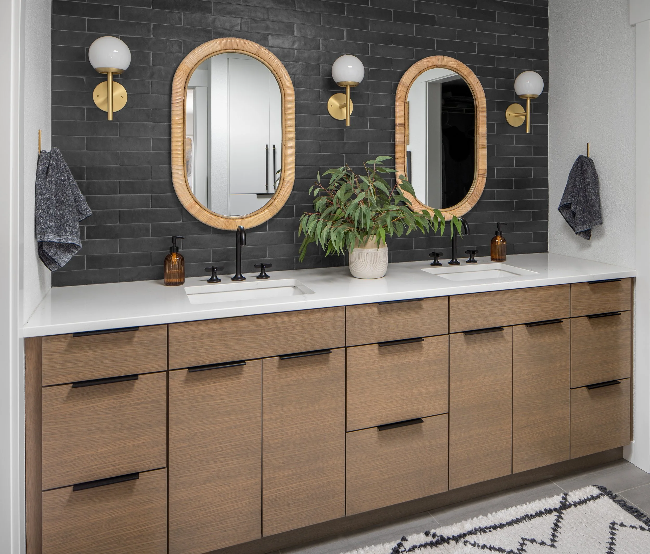 Snohomish, WA | Primary Bathroom Remodel | Double sink vanity with black tile wall and contemporary wood cabinets