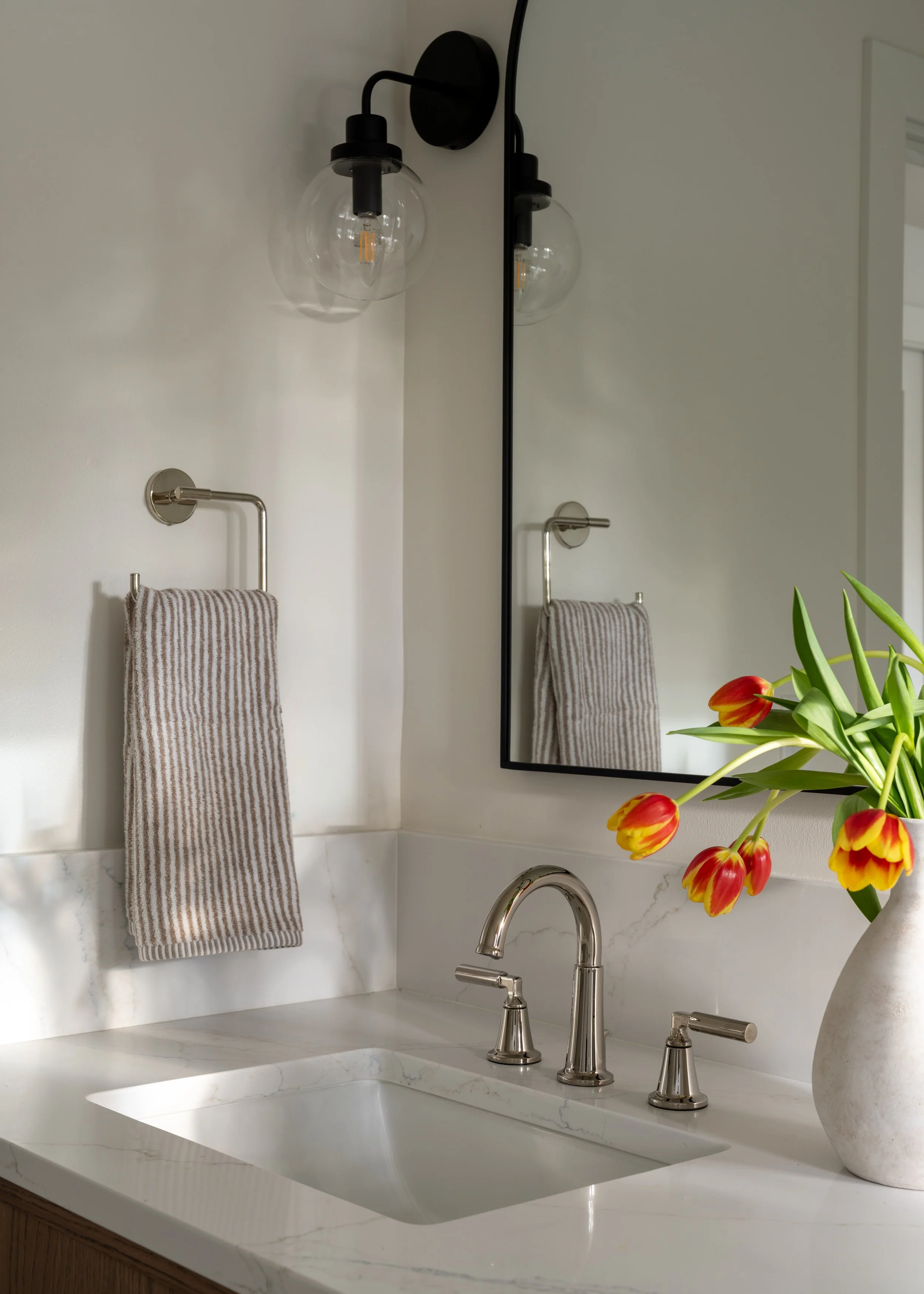 Explore this clean, minimalist Seattle bathroom design by Allison Myers Design. Featuring marble surfaces and brushed nickel fixtures. Photography by Emily Barrows.