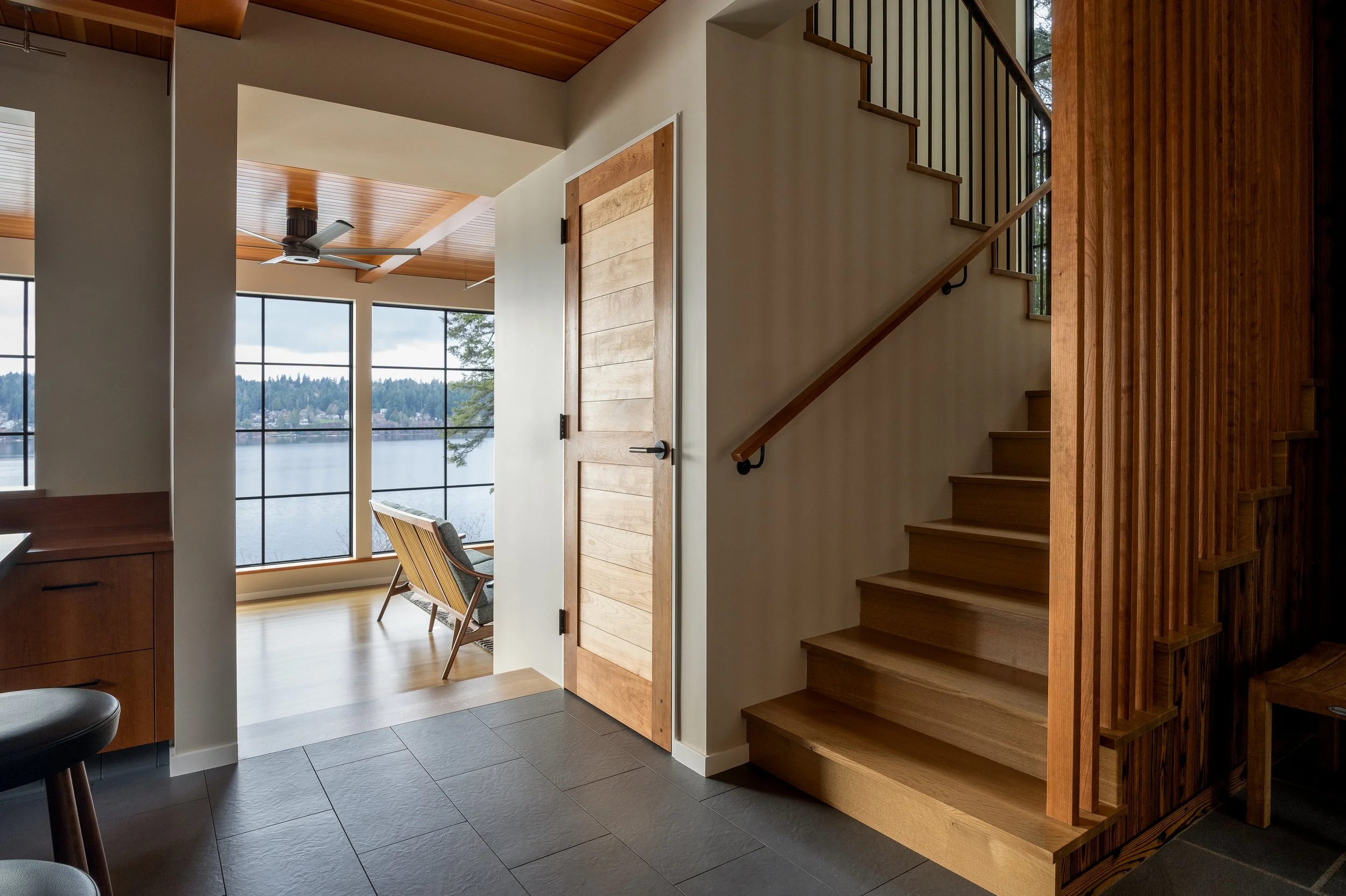 Bainbridge Island | New Construction | View of stairs and living room with Puget Sound view
