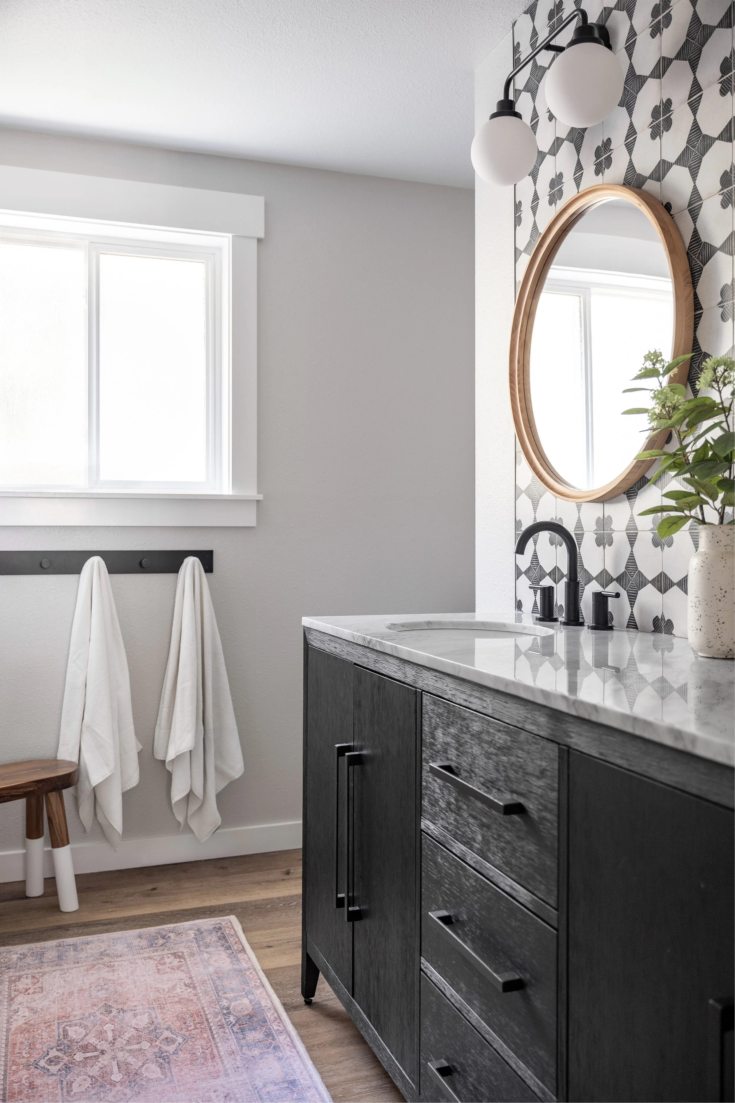 Snohomish, WA | Guest Bath Remodel | Vanity with Round mirror near window with towel rack
