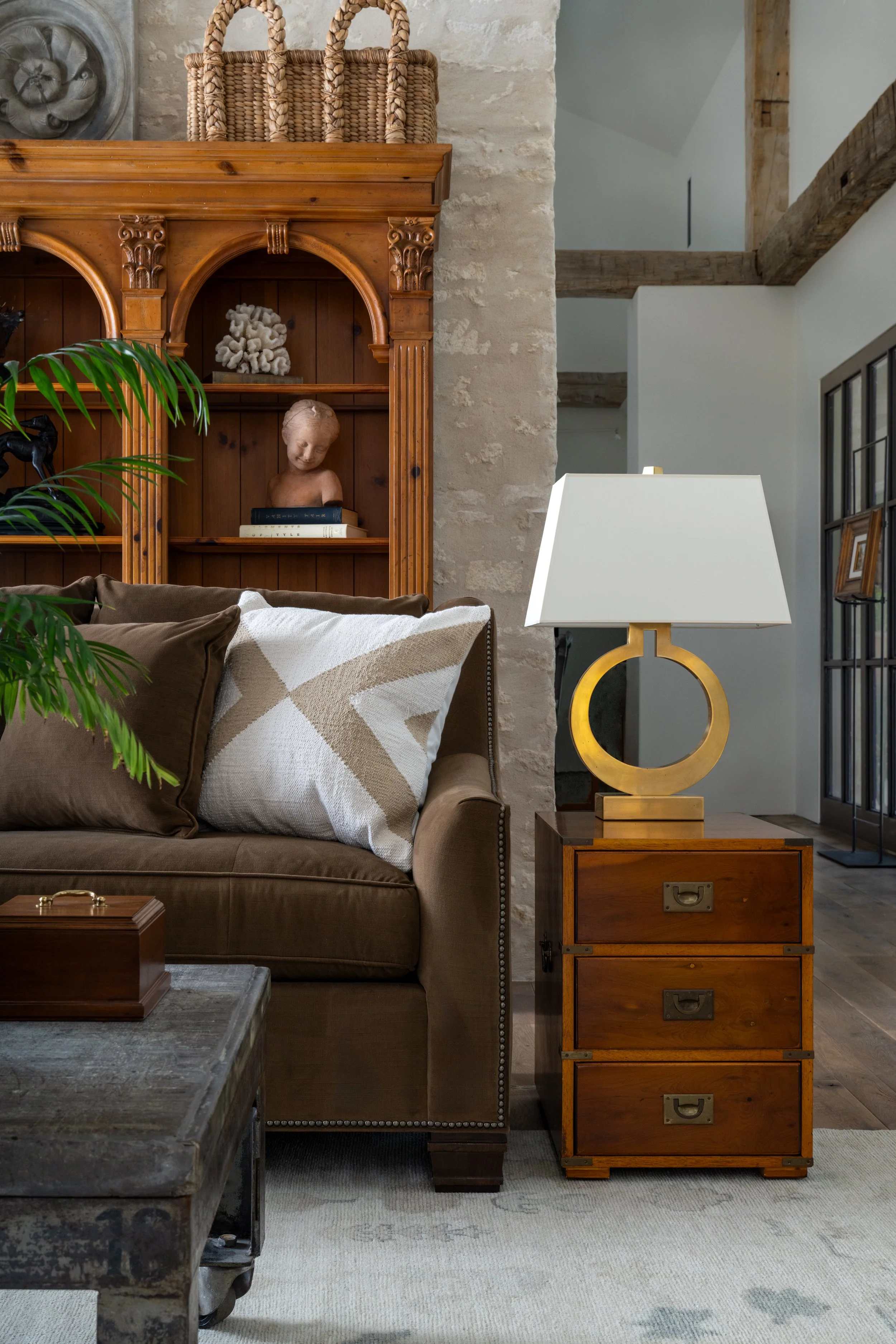 Texas Hill Country | Living Room Design | High Ceiling Room with wood beams, sofa and end table 