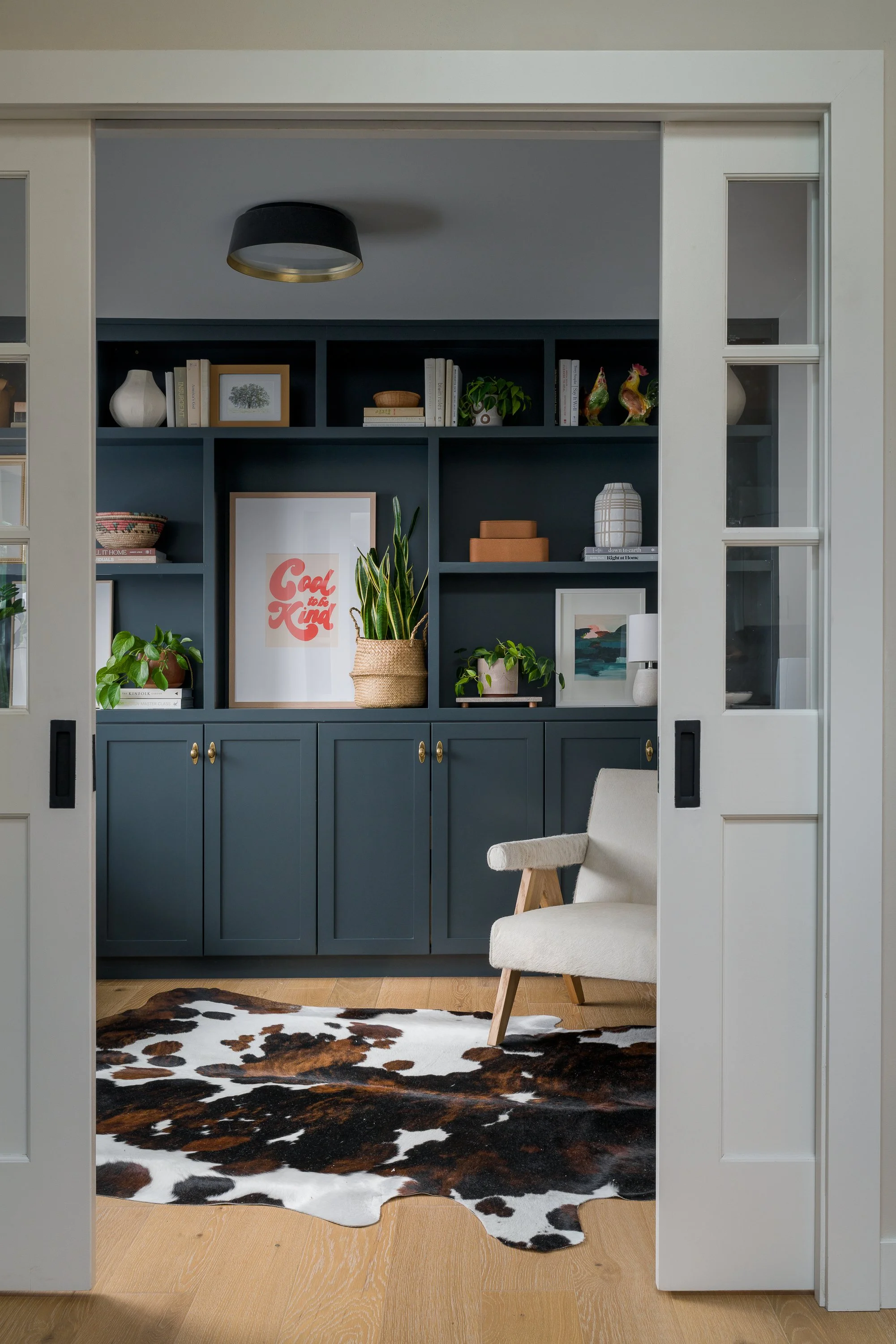 Kirkland | Home Office Remodel | Bookcase with Cowhide and Chair
