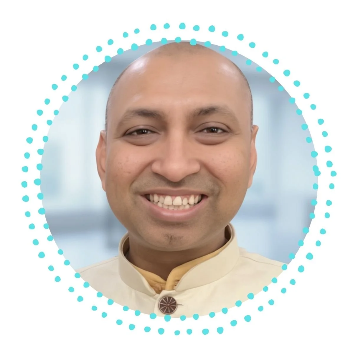 A smiling man with a bald head, wearing a beige traditional Indian kurta with a decorative button, against a light background with blue dotted circle embellishments.