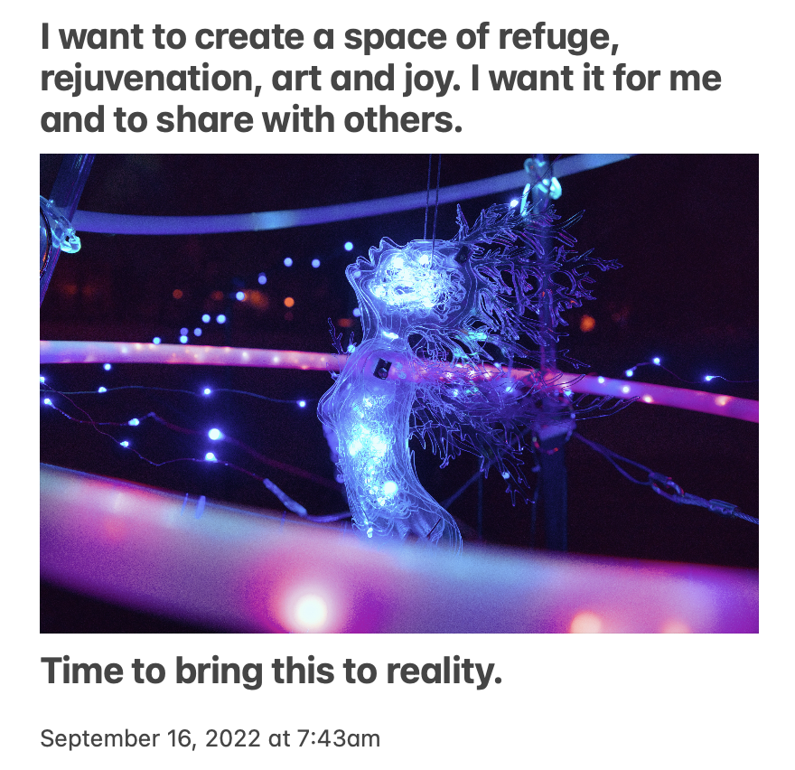 A glowing, abstract sculpture of a human figure with intricate, branching designs and blue lights, surrounded by pink and purple neon lights, in a dark environment.