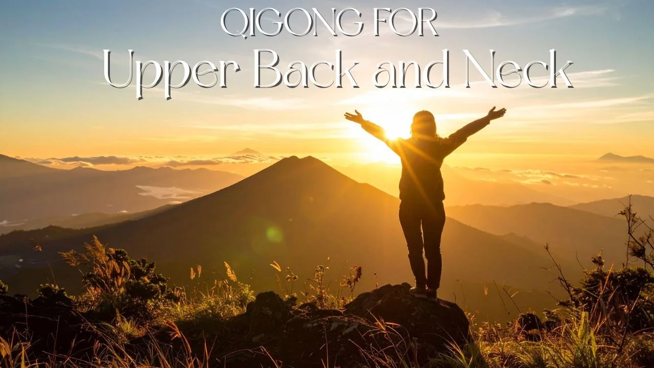 Person standing on a mountain top during sunrise with arms raised in front of a scenic mountainous landscape, drone, and colorful sky, with the text "Qigong for Upper Back and Neck" overlaid.
