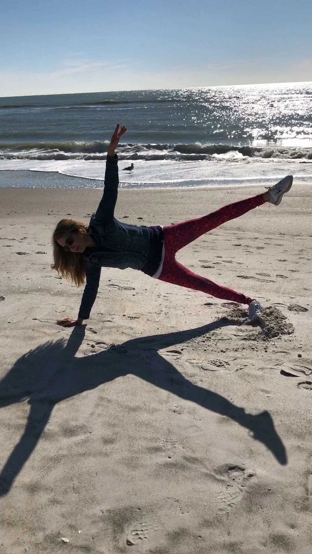 Julie Cheifetz doing Pilates star on the beach