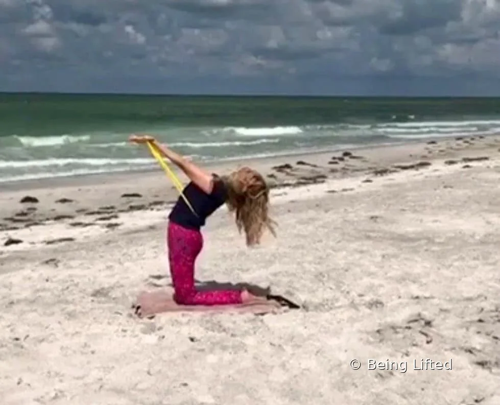 Julie Cheifetz doing Pilates with resistance band on Longboat Key, FL beach