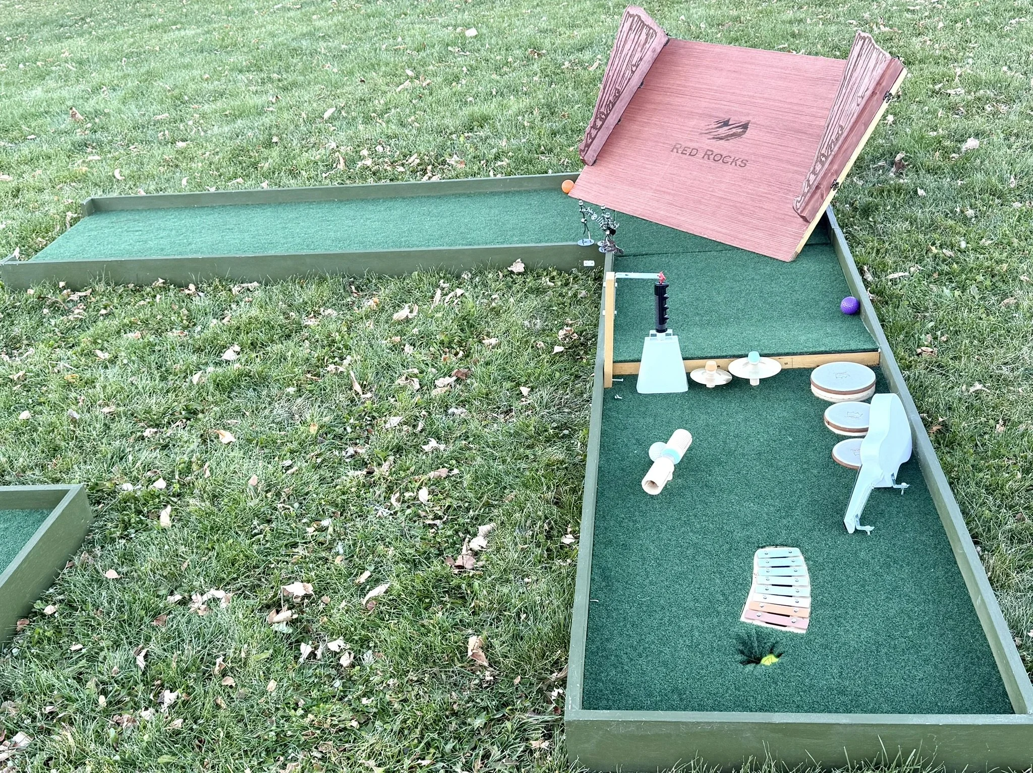 A Red Rocks Amphitheater themed mobile mini golf course with ukulele, drums, cow bell and xylophone.