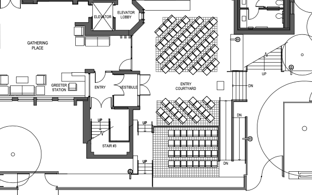 Floor plan of a building's interior showing a gathering place, greeter station, entry vestibule, entry courtyard, elevator lobby with two elevators, staircase, and seating areas.