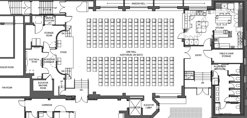 Floor plan of a building showing an auditorium, backstage area, storage, kitchen, restrooms, and various rooms with elevators.