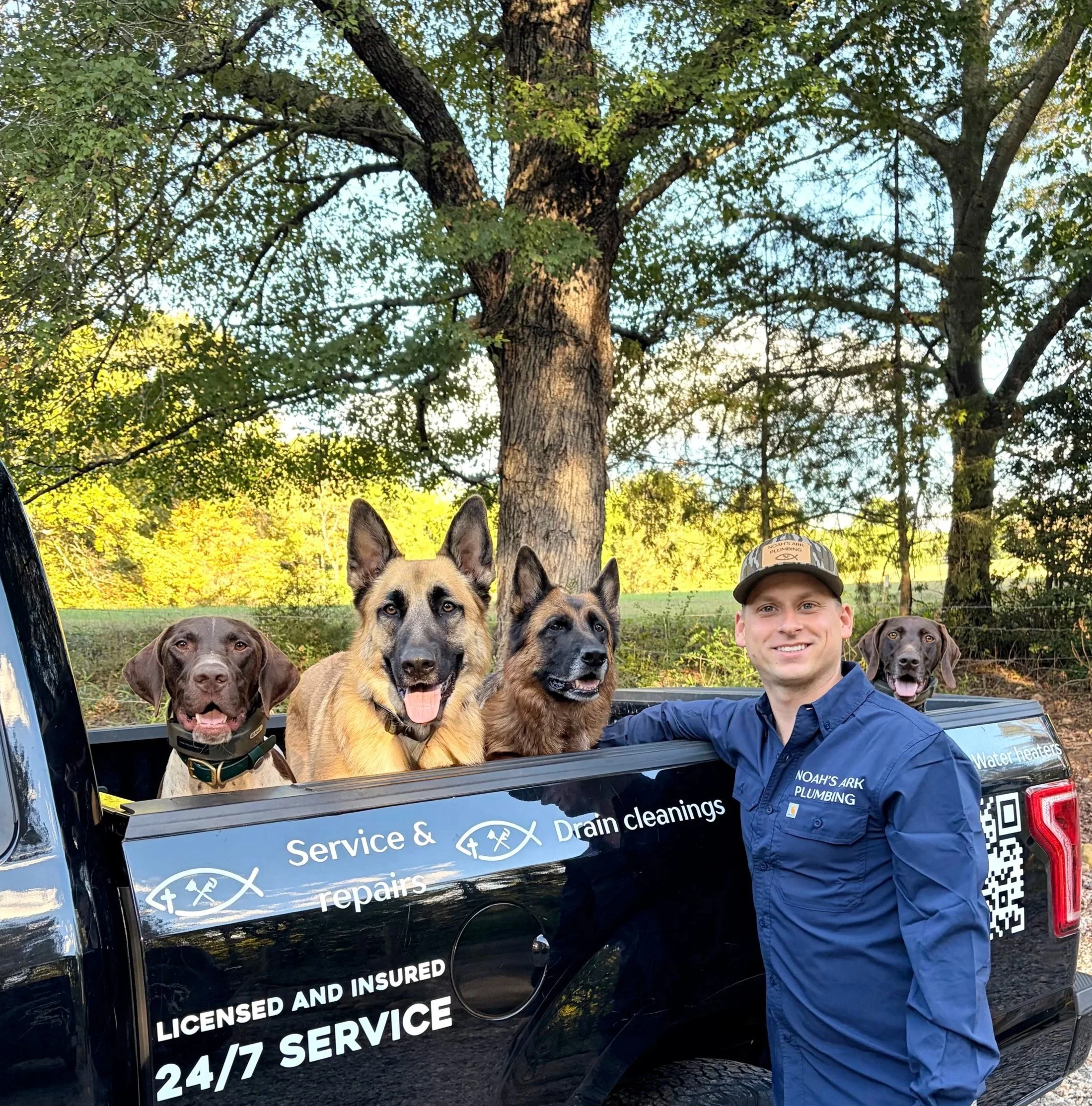 Owner of Noah's Ark Plumbing in Easley SC standing with his dogs