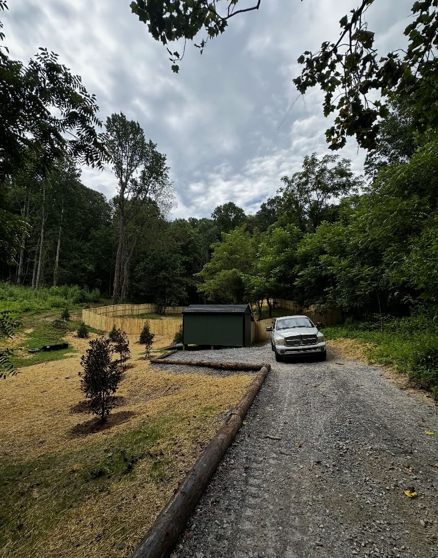 Land clearing and site preparation project with newly cleared property and gravel access by Hazy River Earthworks