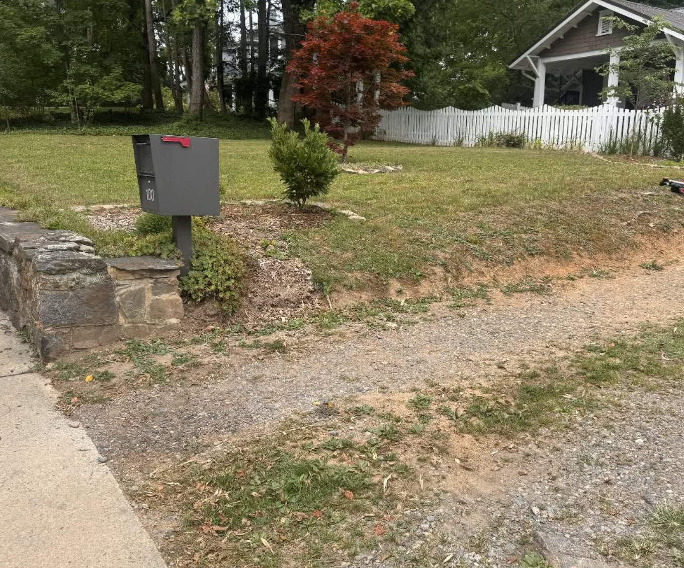 Existing gravel driveway before grading, reshaping, and fresh gravel placement for improved access and drainage.