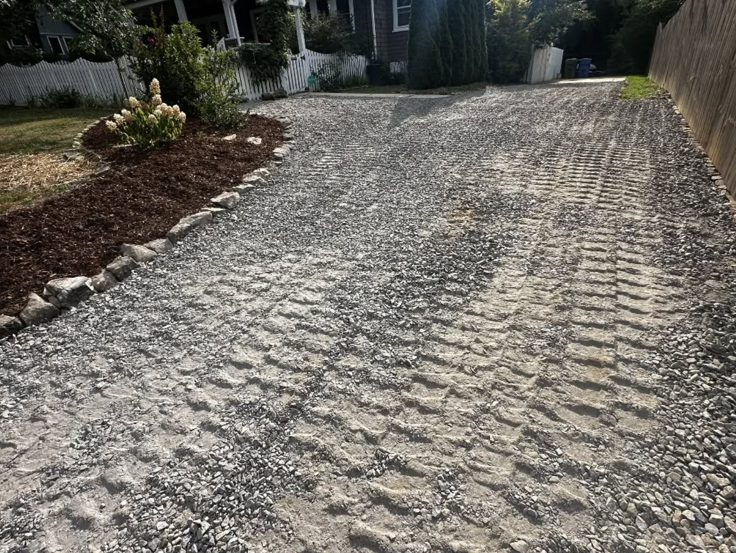 Freshly graded gravel driveway providing improved durability, drainage, and curb appeal for a residential property.