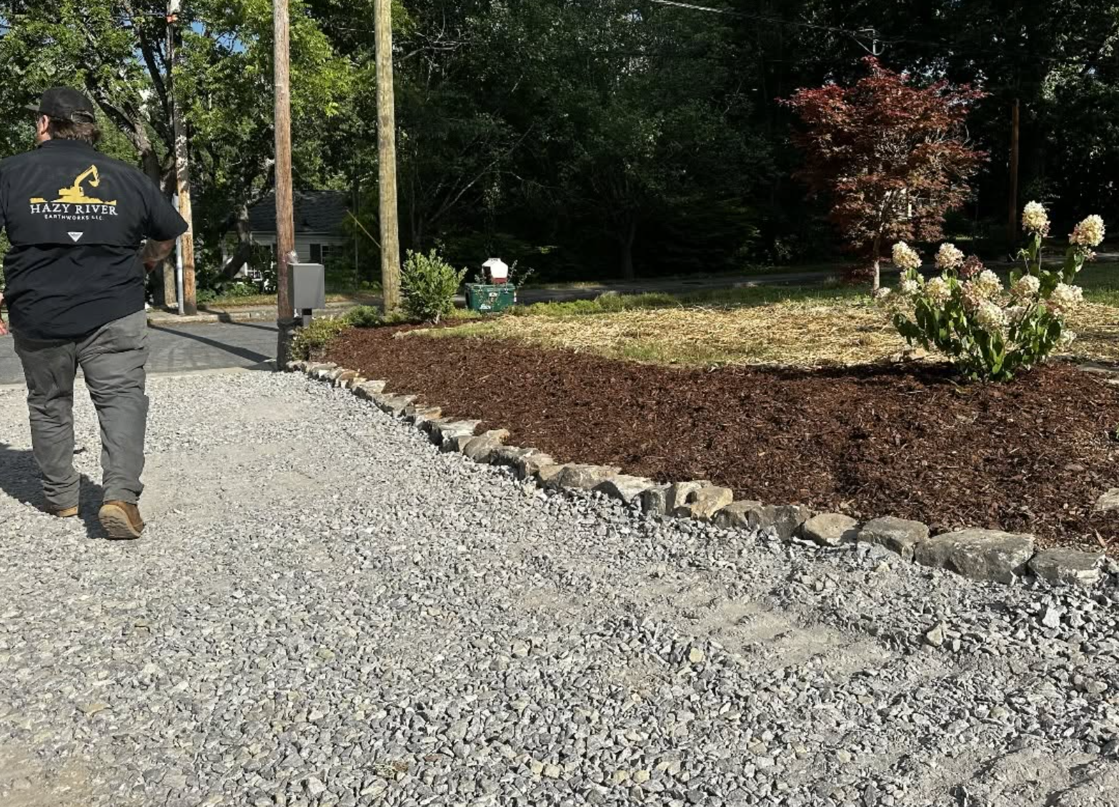 Completed residential gravel driveway showcasing professional excavation, grading, and fresh stone installation by Hazy River Earthworks.