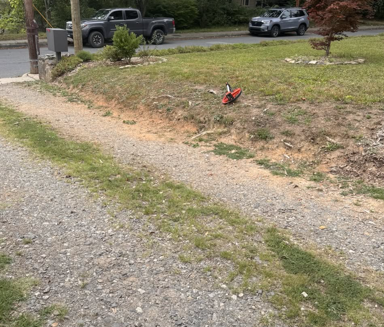 Residential driveway before excavation, grading, and gravel driveway improvements by Hazy River Earthworks.