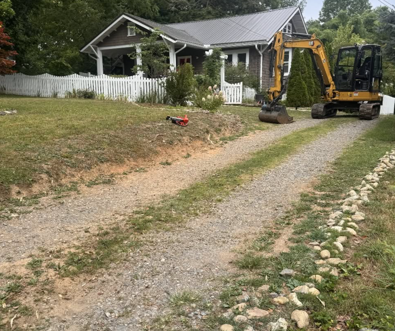 Before photo of an existing gravel driveway prior to grading and new gravel installation by Hazy River Earthworks.