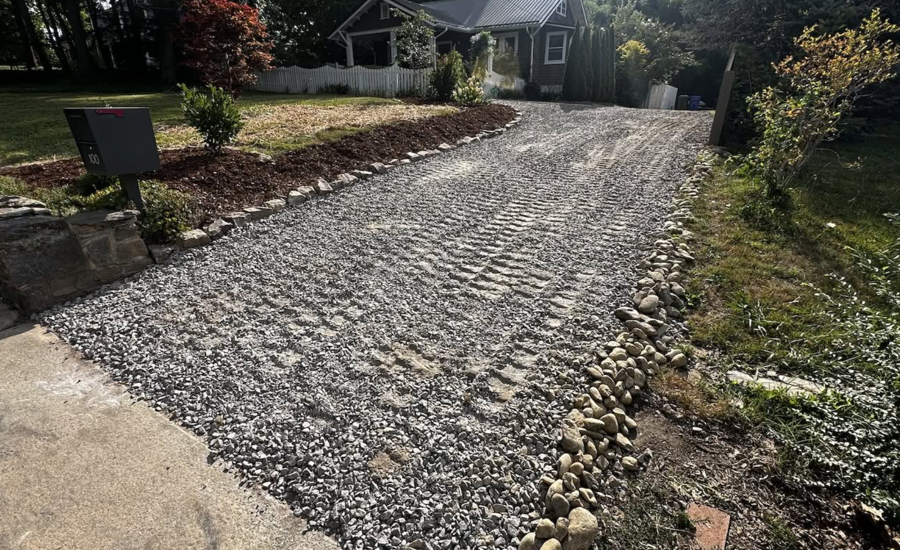 Completed gravel driveway installation with fresh stone, proper grading, and improved drainage by Hazy River Earthworks.