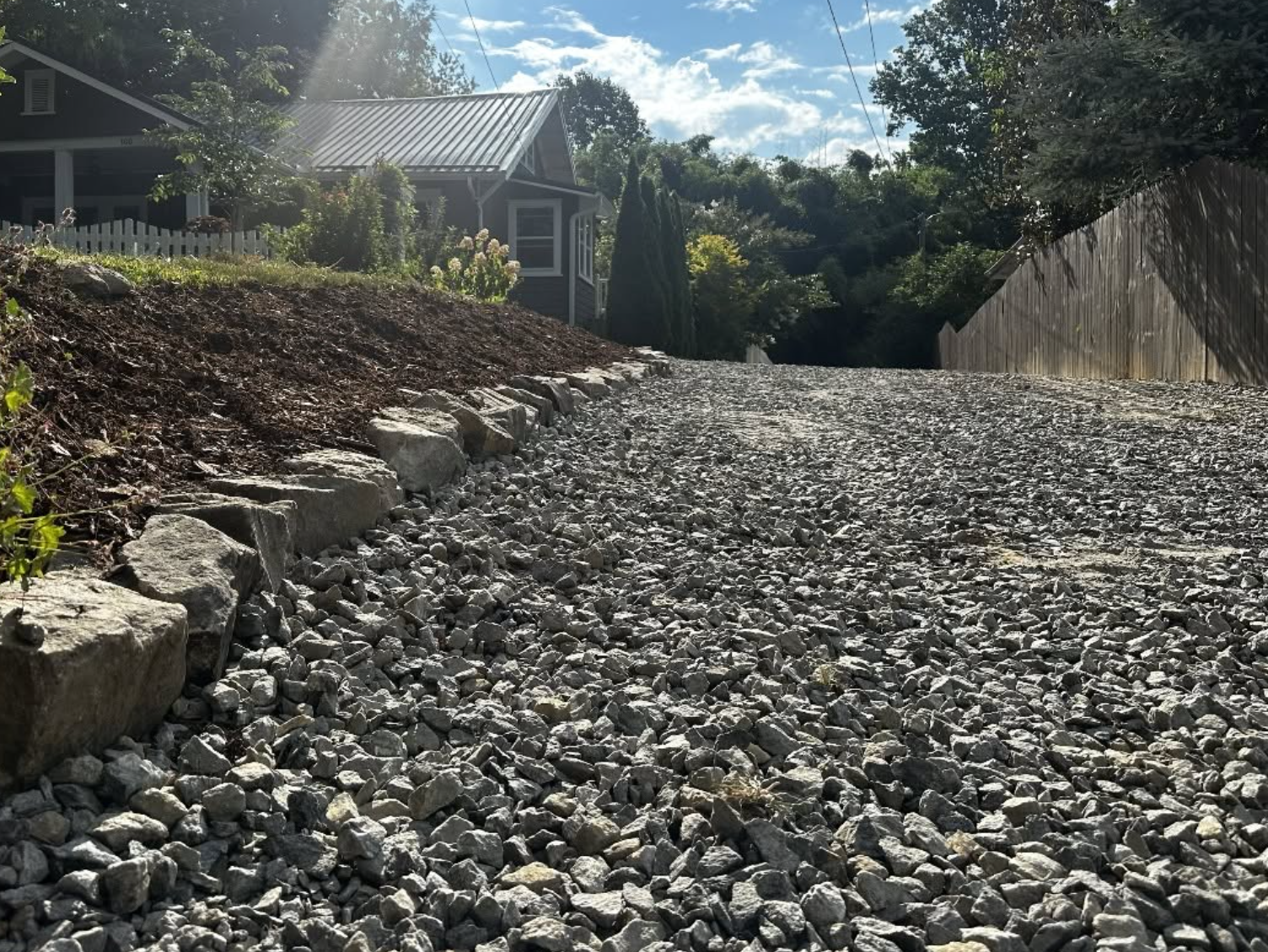Completed residential gravel driveway showcasing professional excavation, grading, and fresh stone installation by Hazy River Earthworks.