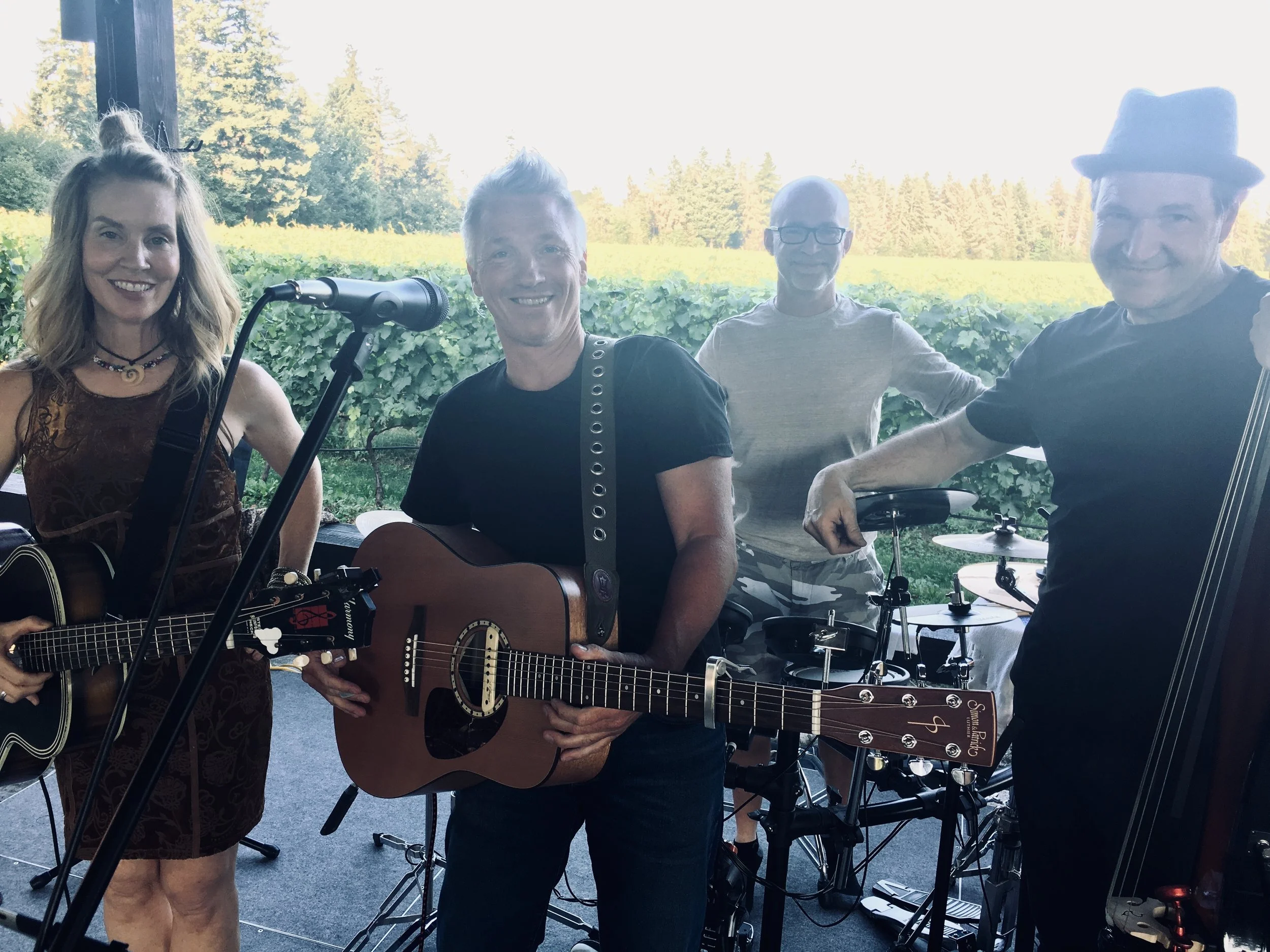 Four musicians playing instruments outdoors at 40 knots winery
