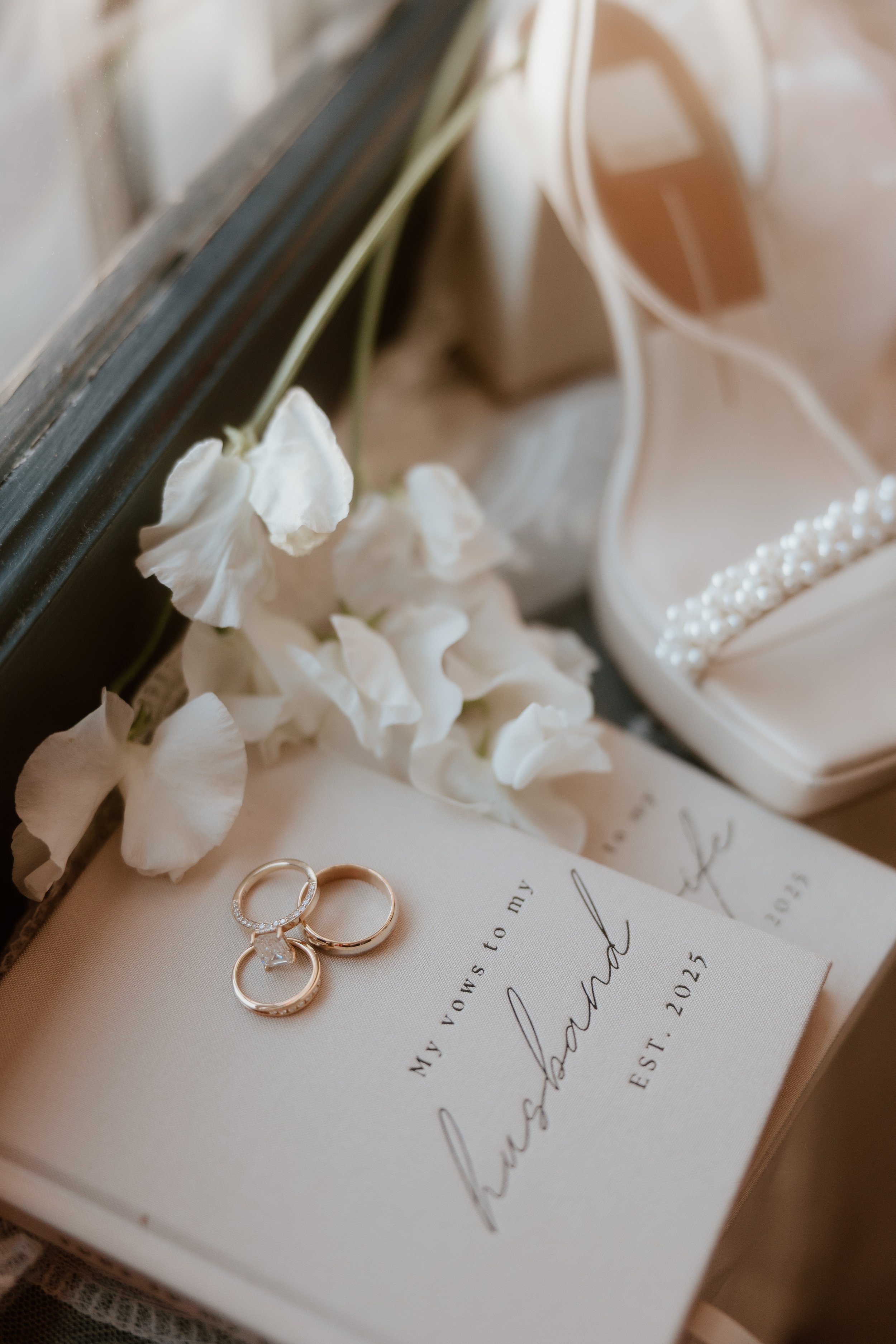 wedding vow books styled with soft neutral details and elegant accessories