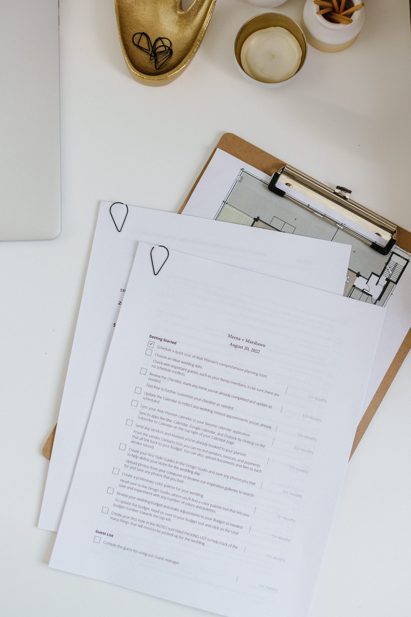wedding planning documents and timeline details on clipboard