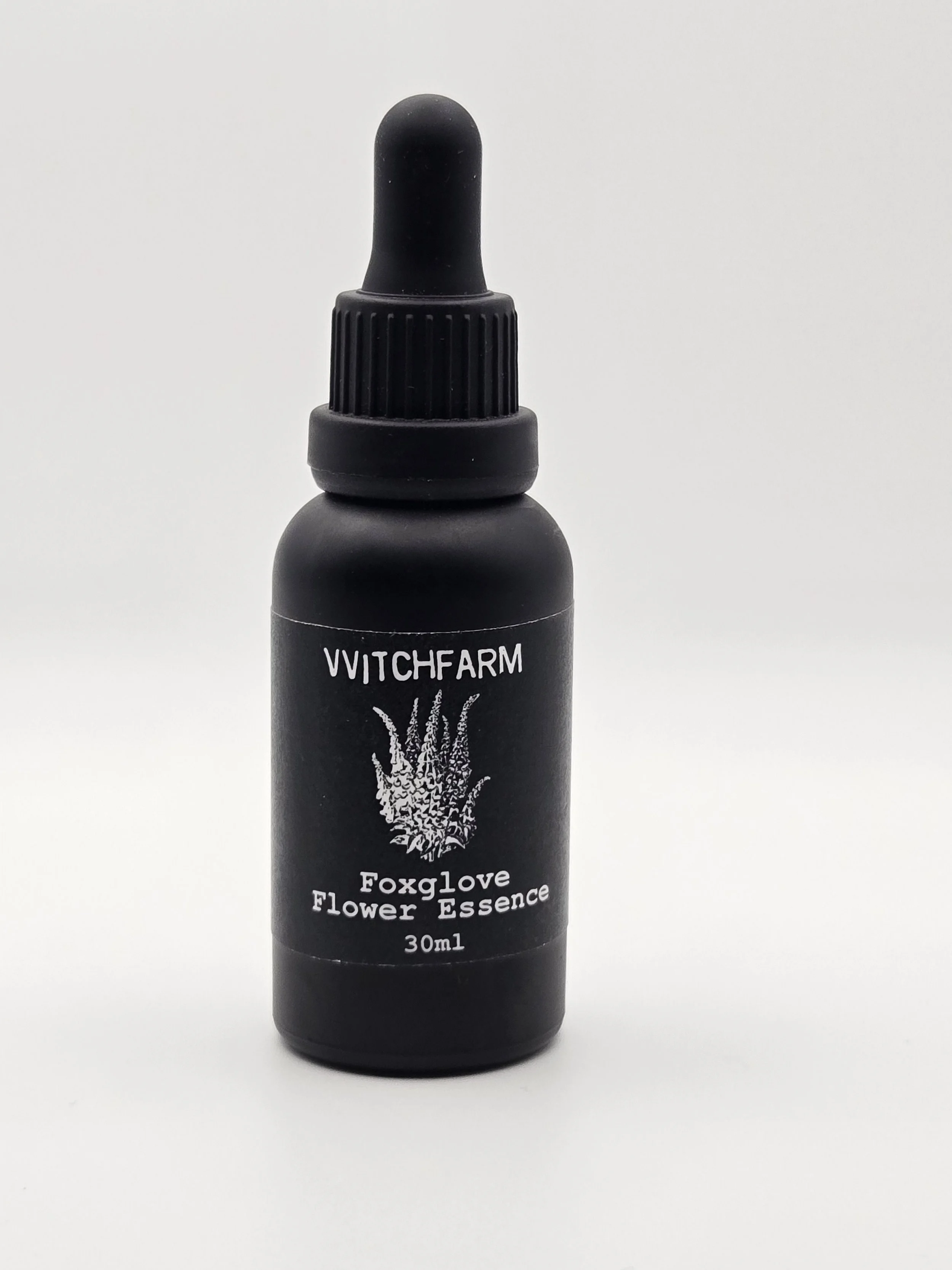 Black bottle of Witchfarm Foxglove Flower Essence with a dropper cap, label displaying a foxglove illustration, and text indicating 30ml volume.