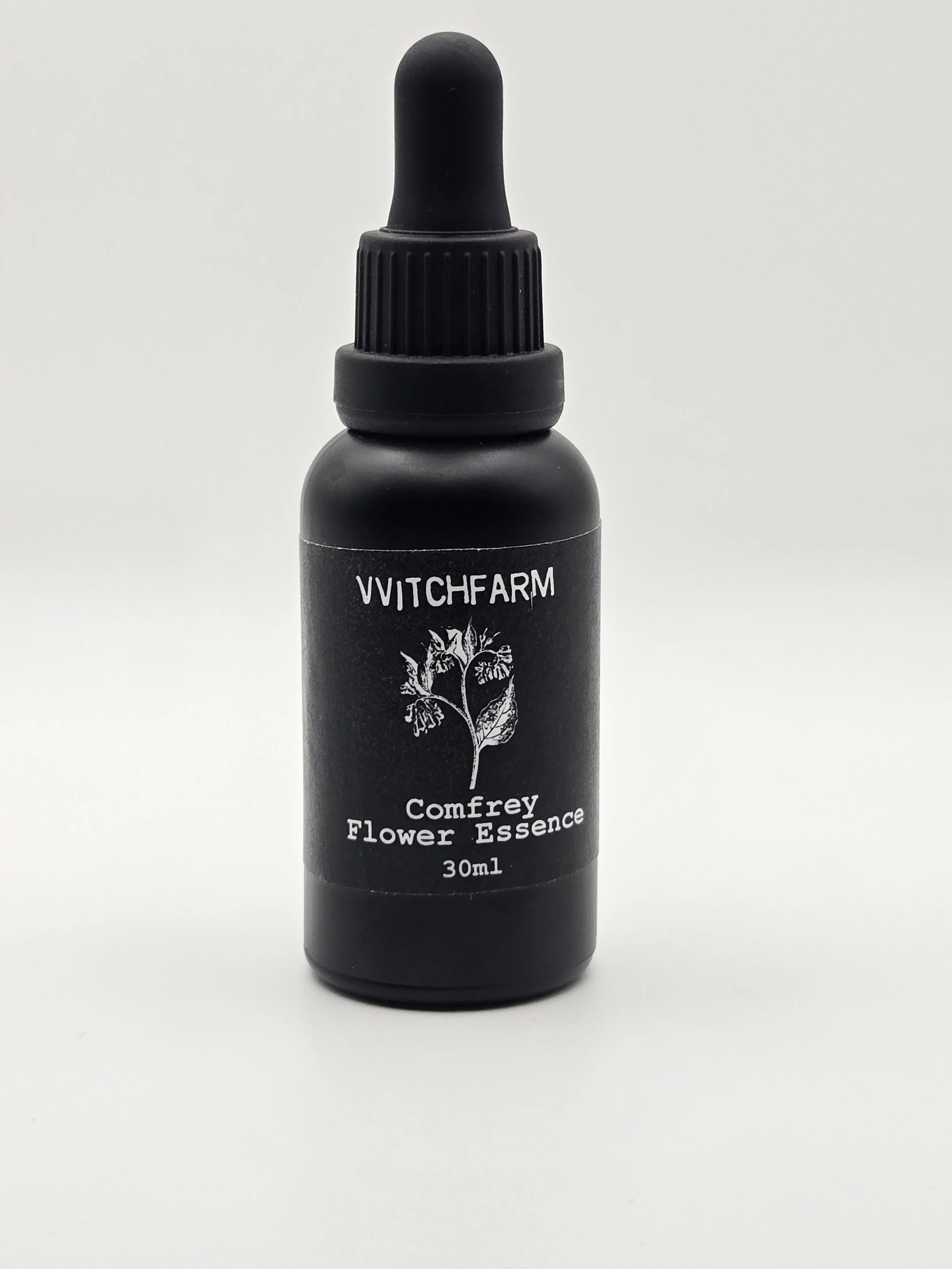 A small black bottle with a dropper cap labeled 'WITCHFARM Comfrey Flower Essence 30ml' on a plain white background.