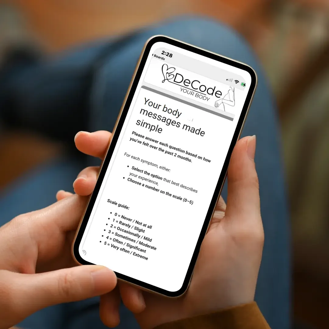 A person holding a smartphone showing a health app called 'DeCode Your Body' with instructions for a simple body message questionnaire, including scale guide and symptom options.