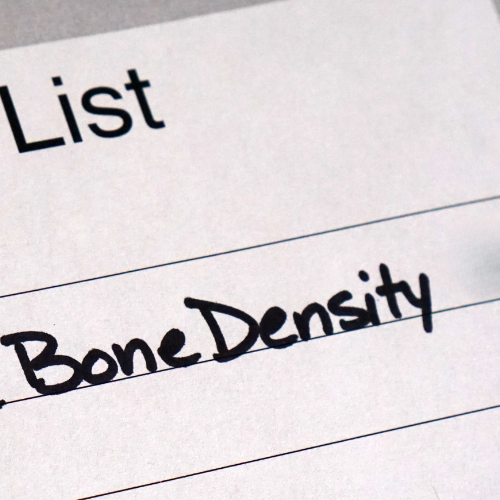 Close-up of a handwritten note on lined paper that says 'Bone Density' in black marker.